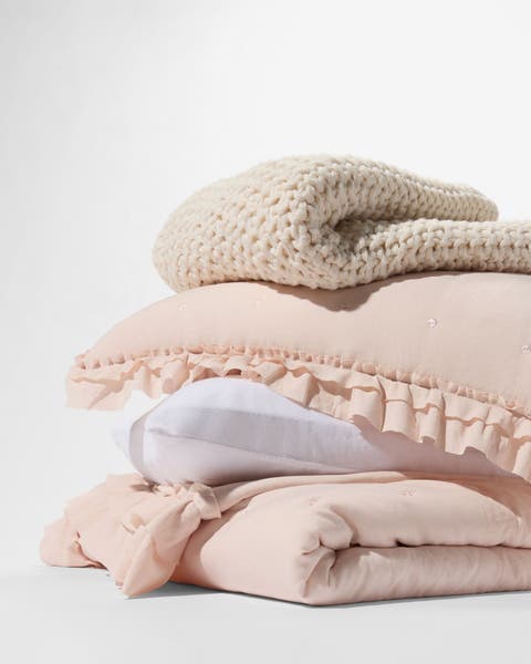 A stack of blankets and pillows.