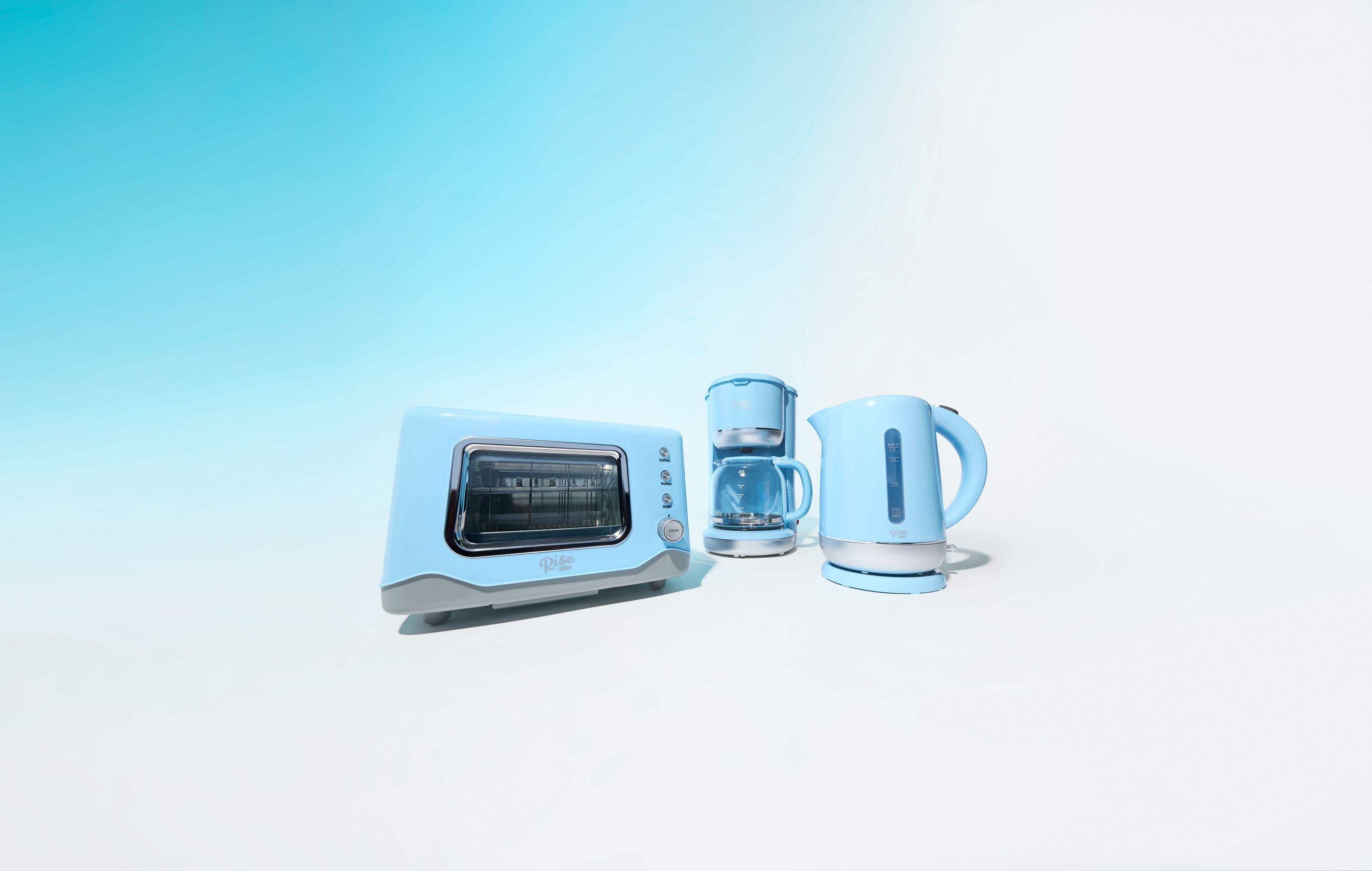 A light-blue toaster oven, coffeemaker and electric kettle.
