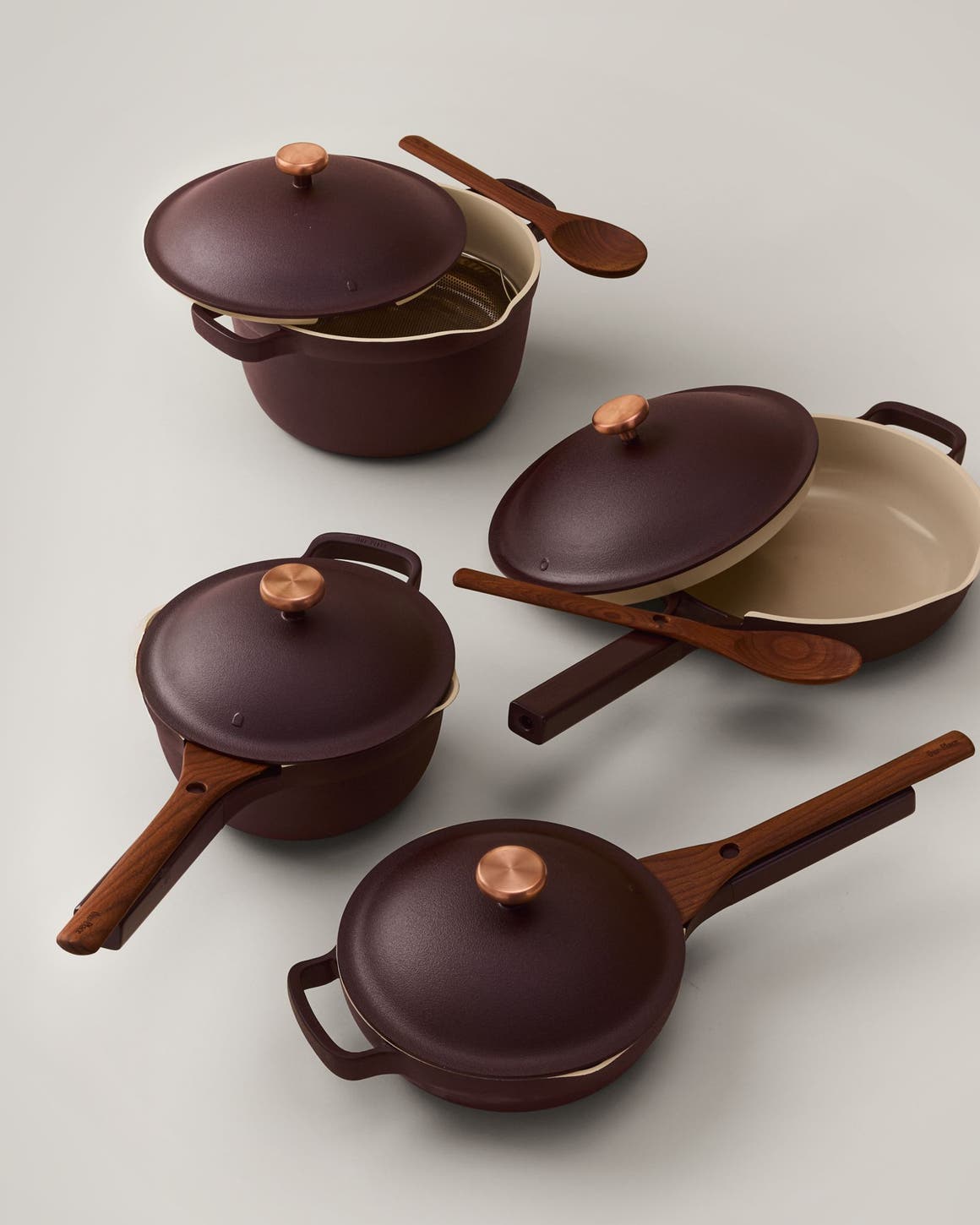 Four lidded pans with spatulas.