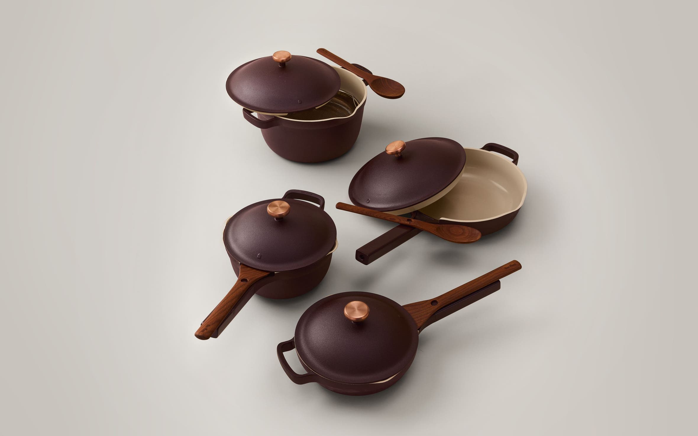 Four lidded pans with spatulas.