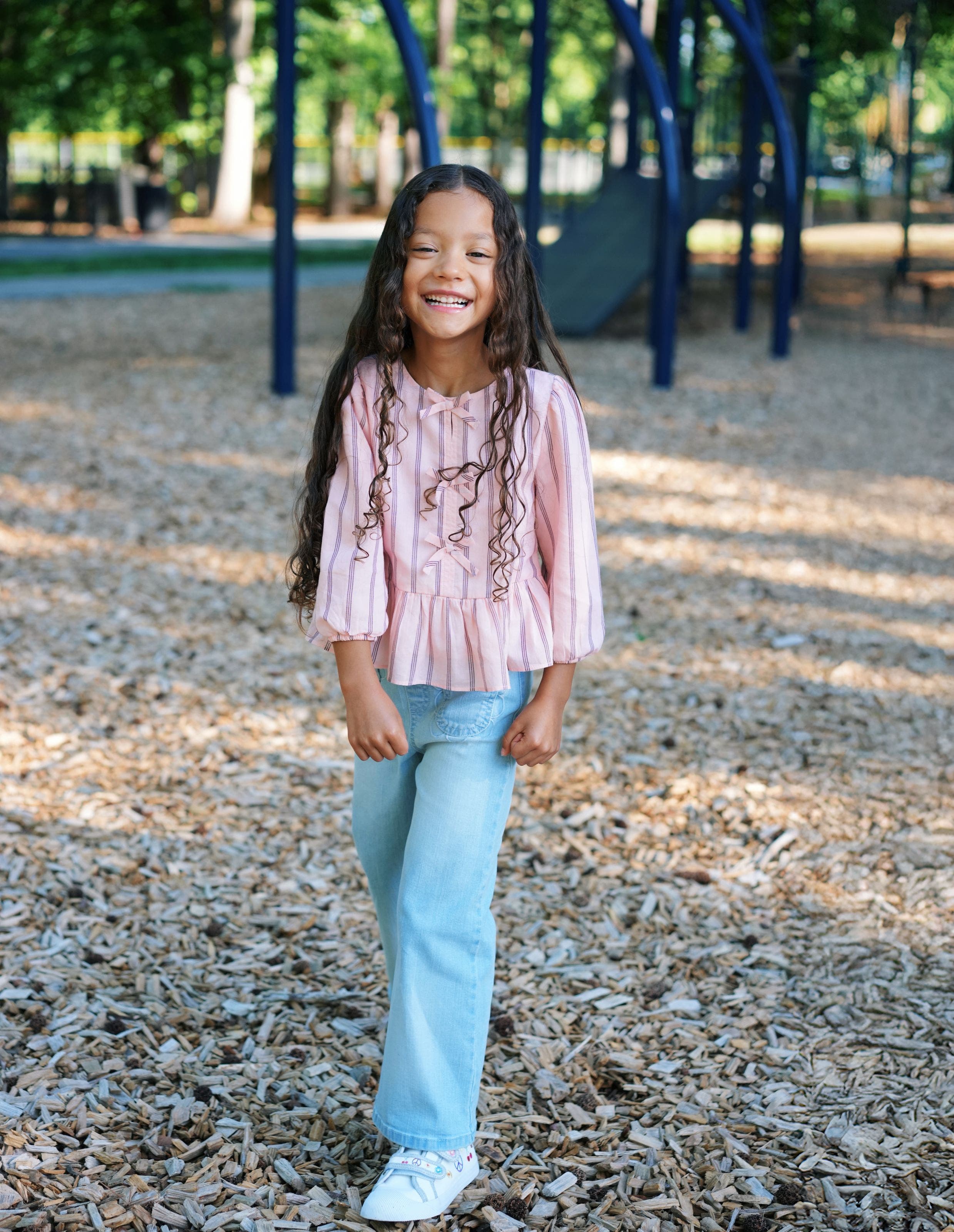 A girl wearing a cute back-to-school outfit.