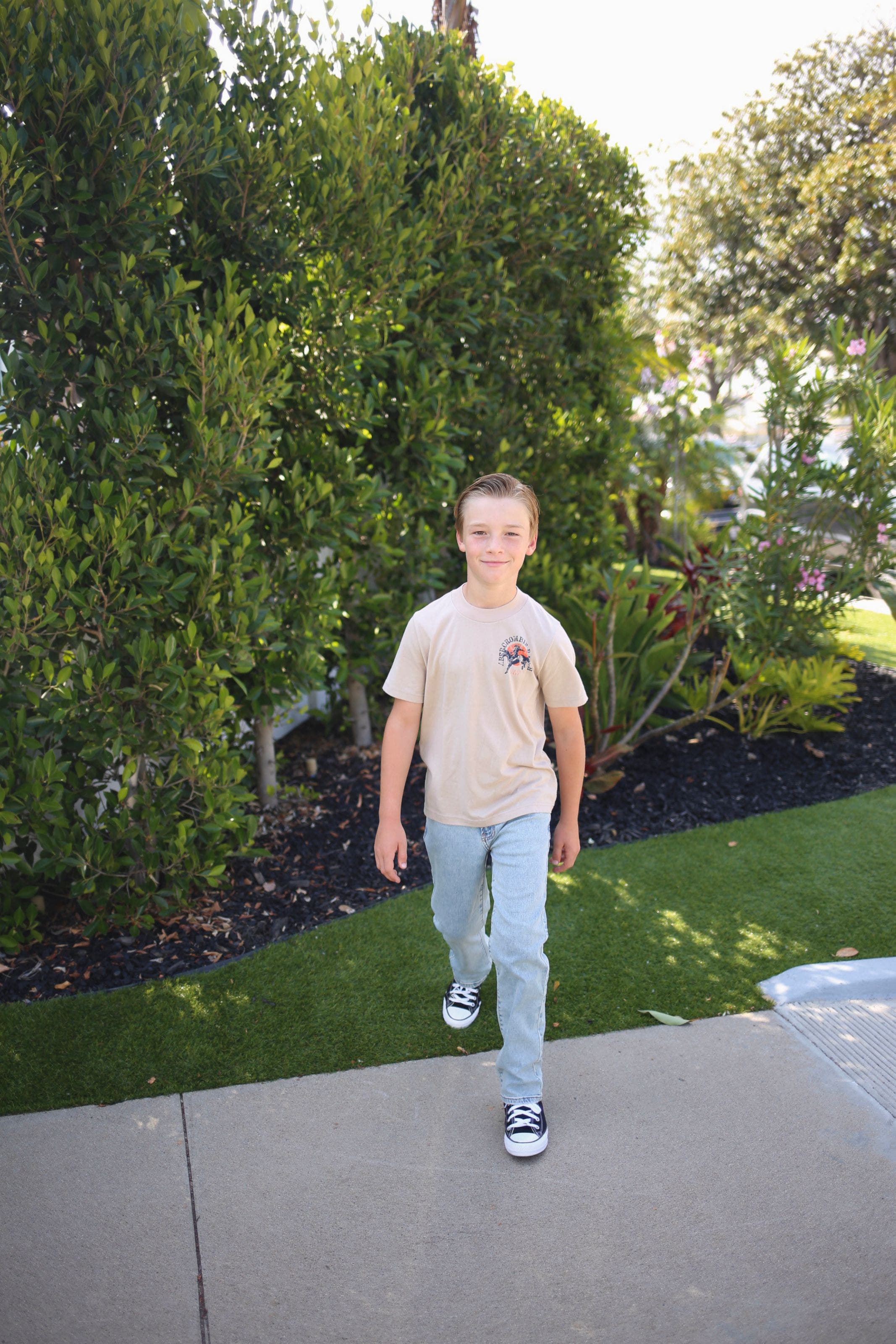 A boy wearing a casual back-to-school outfit.