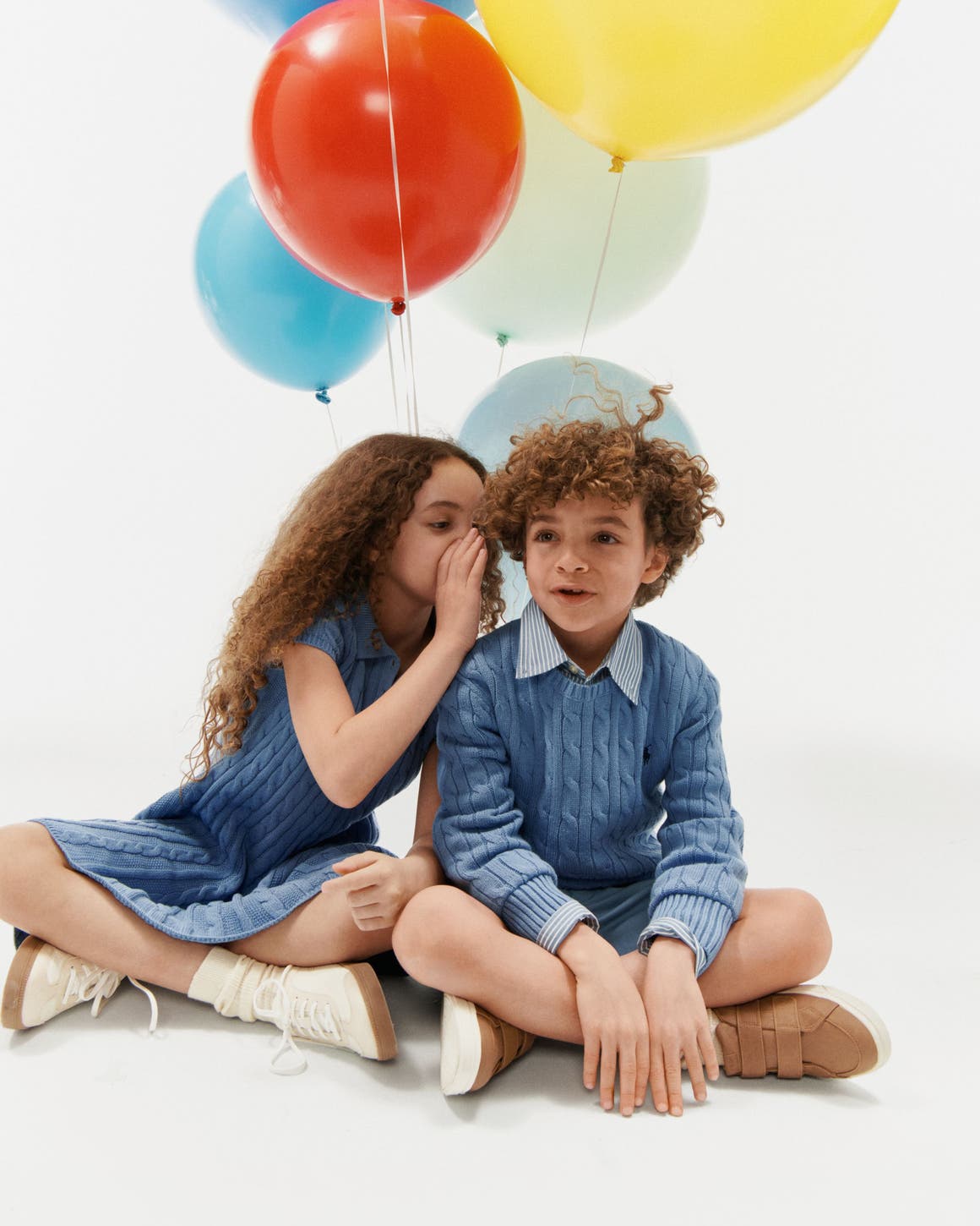 Kids in Anniversary Sale styles next to balloons.