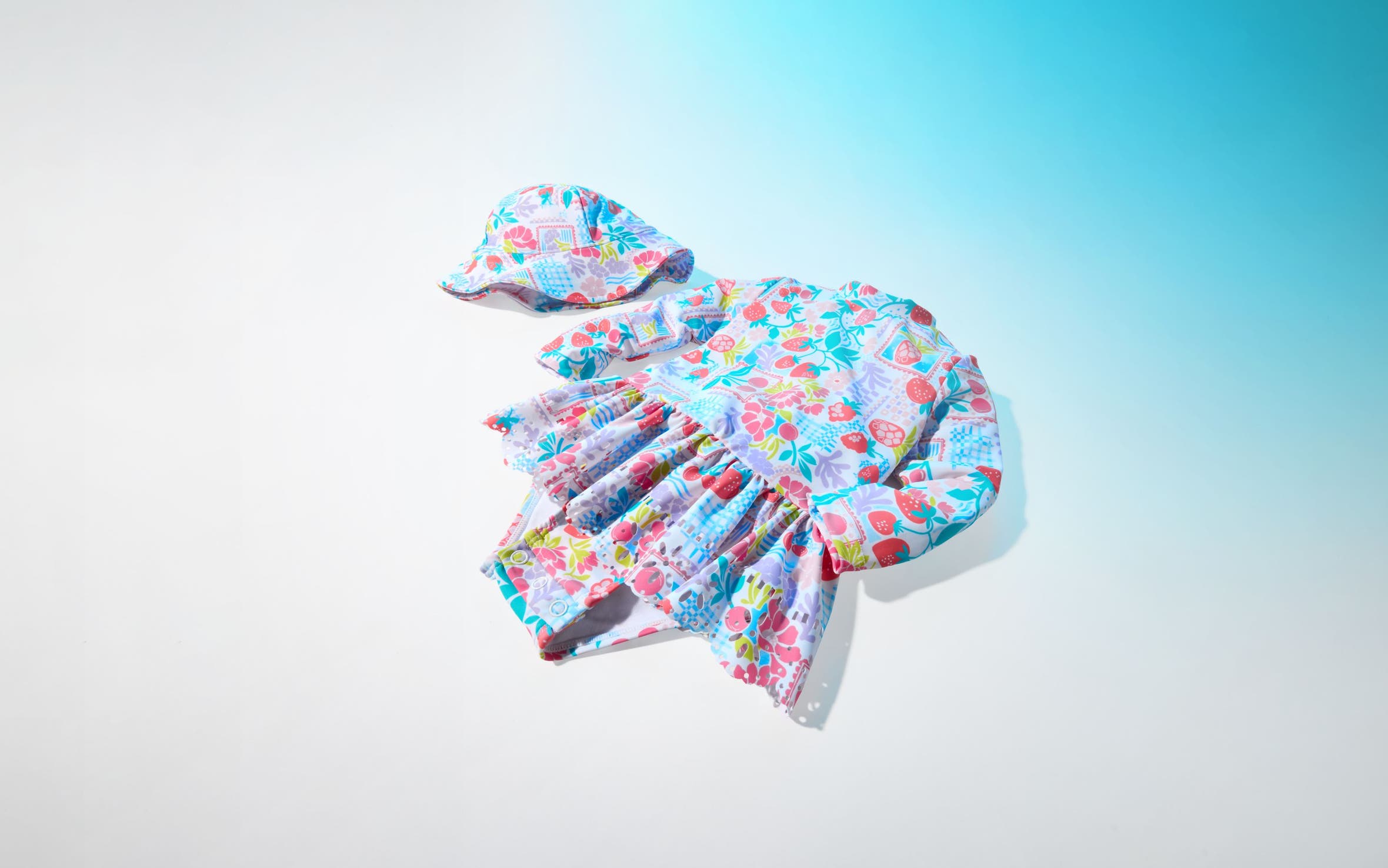 A colorful printed one-piece and matching hat.