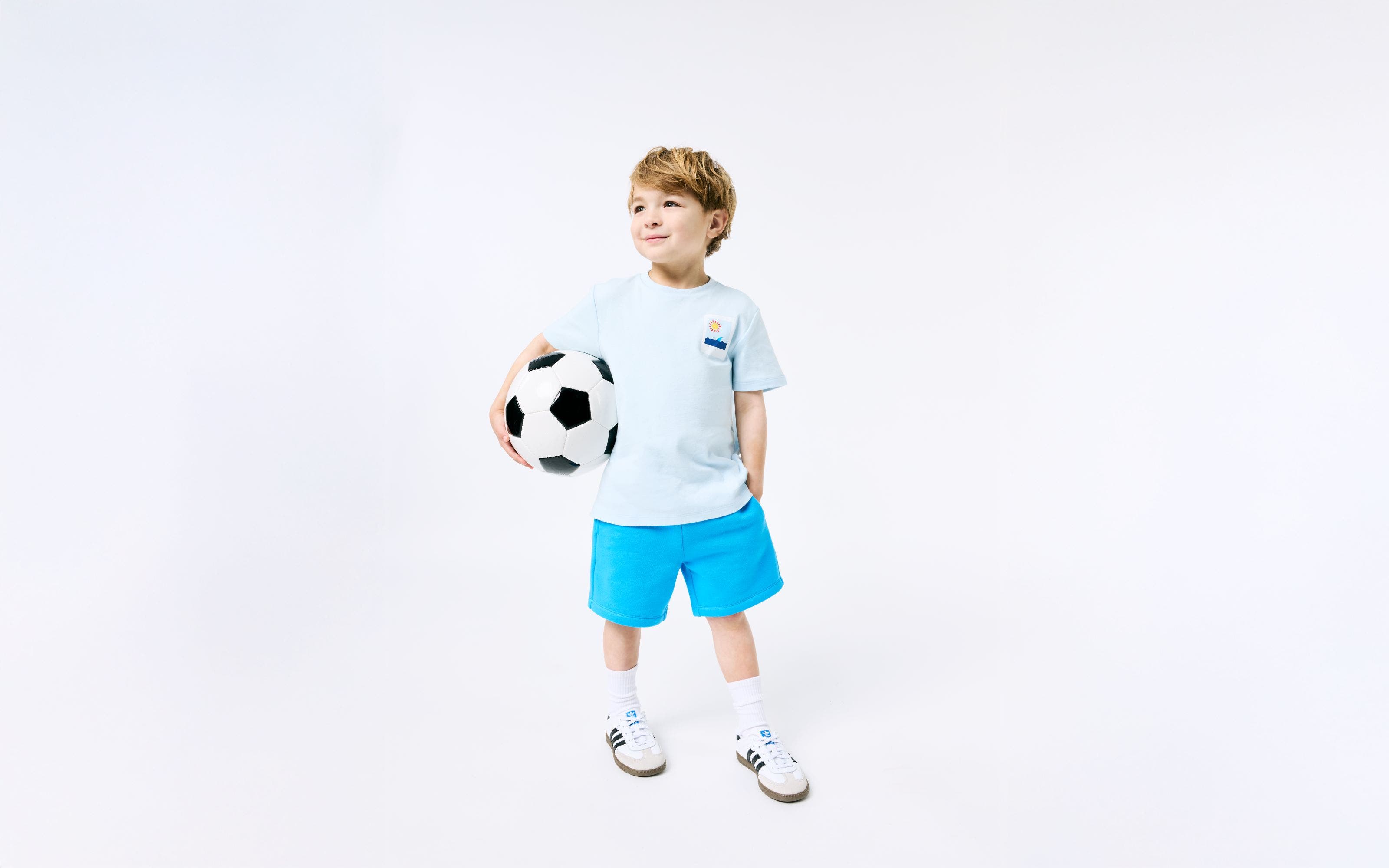 A boy holding a soccer ball.