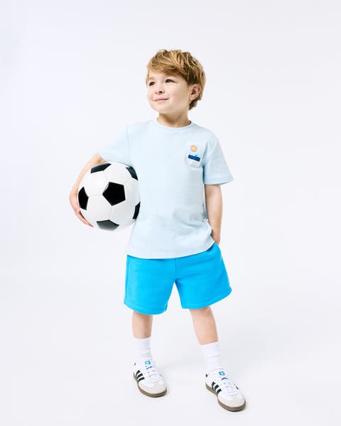 A boy holding a soccer ball.