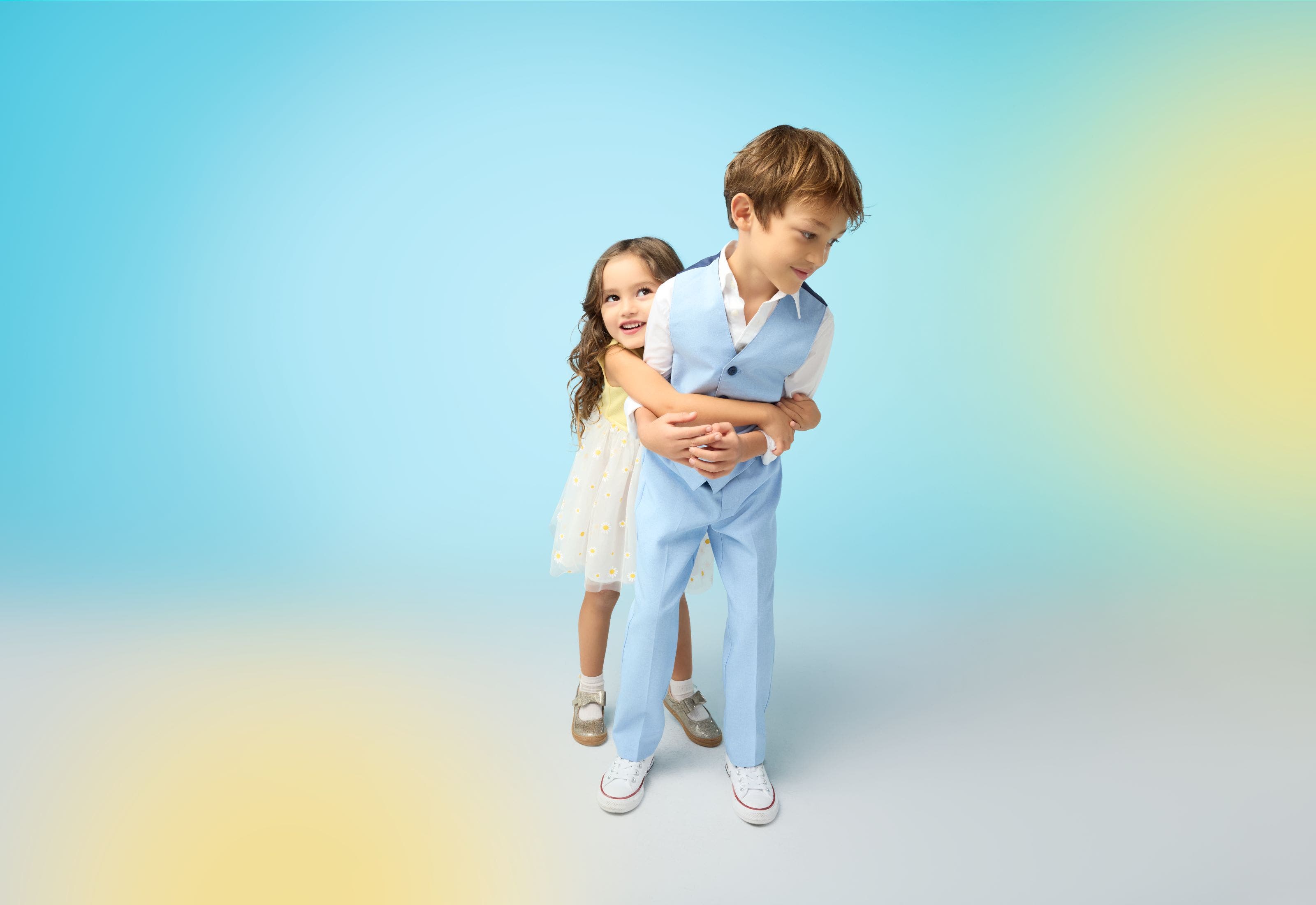 A girl in a white dress and a boy in a blue suit.