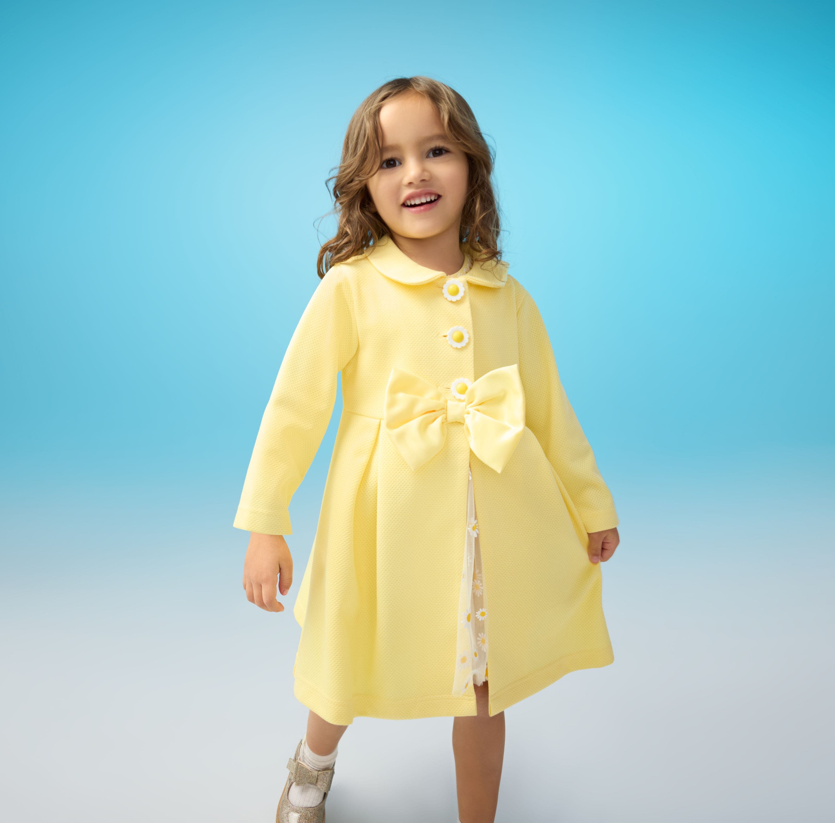 A child wearing a yellow dress. 