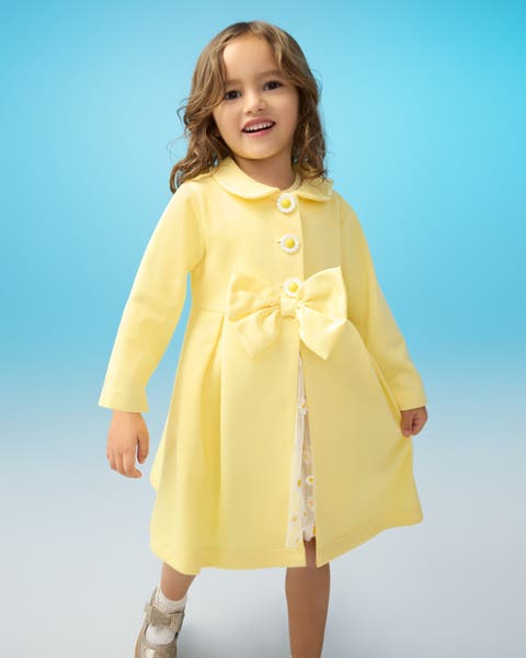 A child wearing a yellow dress.