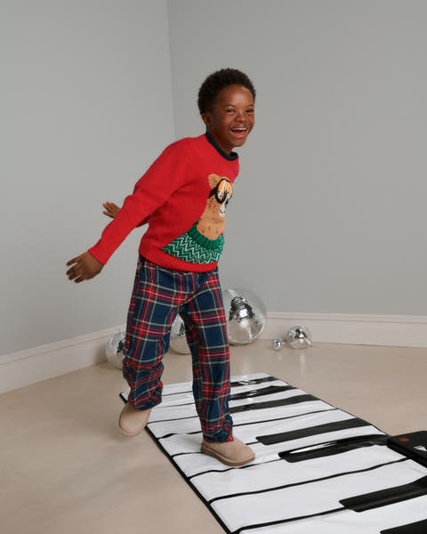 A boy on a piano mat.