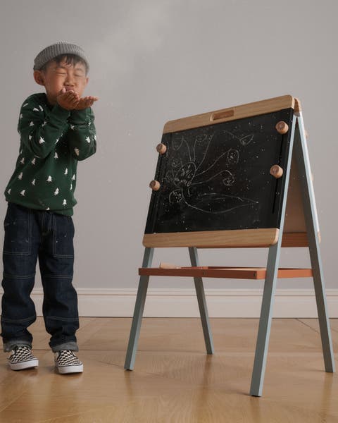 A boy with a chalkboard easel.