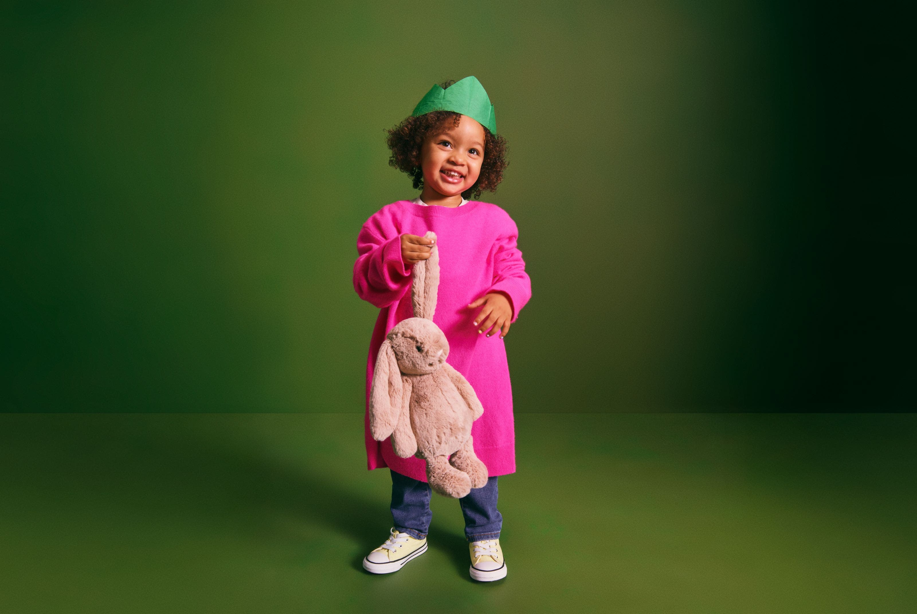 A little girl with a stuffed bunny.