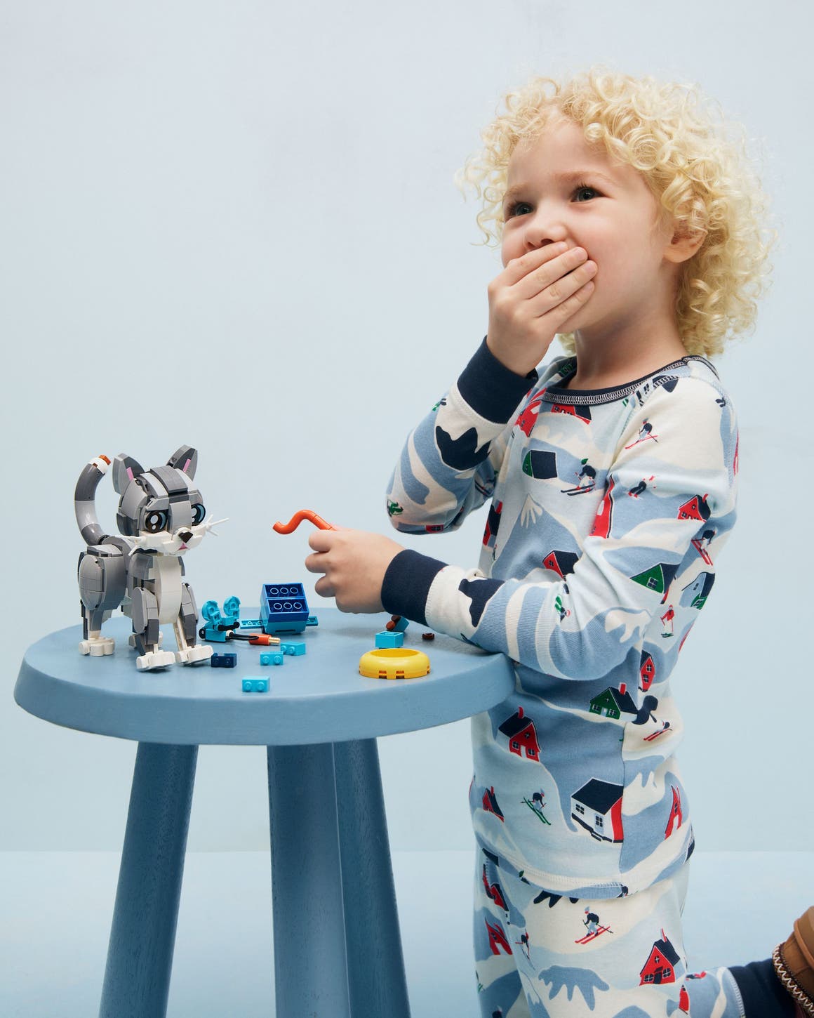 A child building a Lego cat.