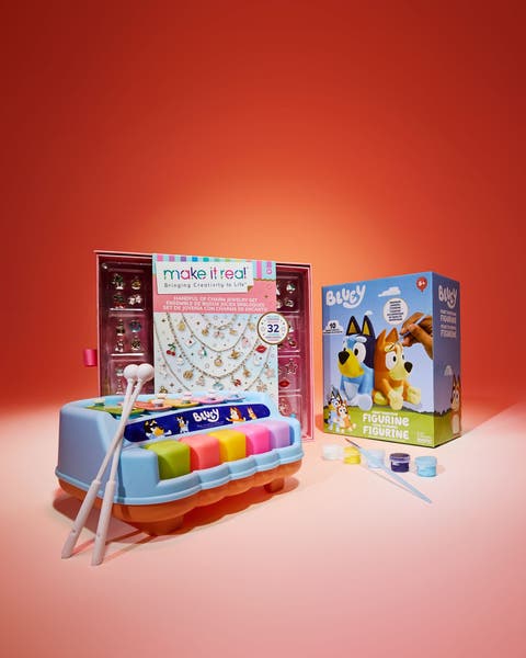 Children's gift set featuring a Make It Real charm jewelry kit, a Bluey xylophone, and a Bluey paint-your-own figurine set.