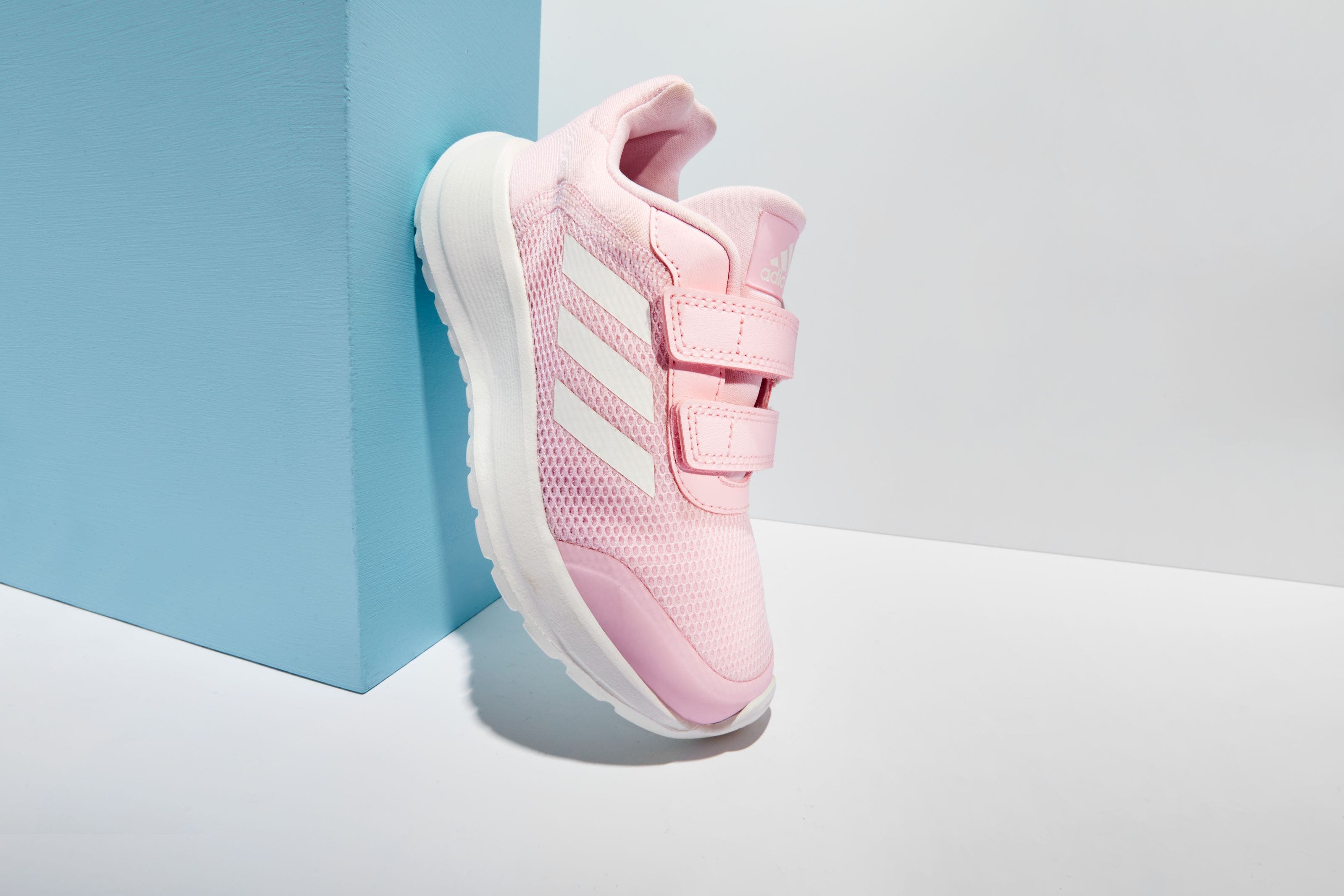 A girls’ pink adidas sneaker. 