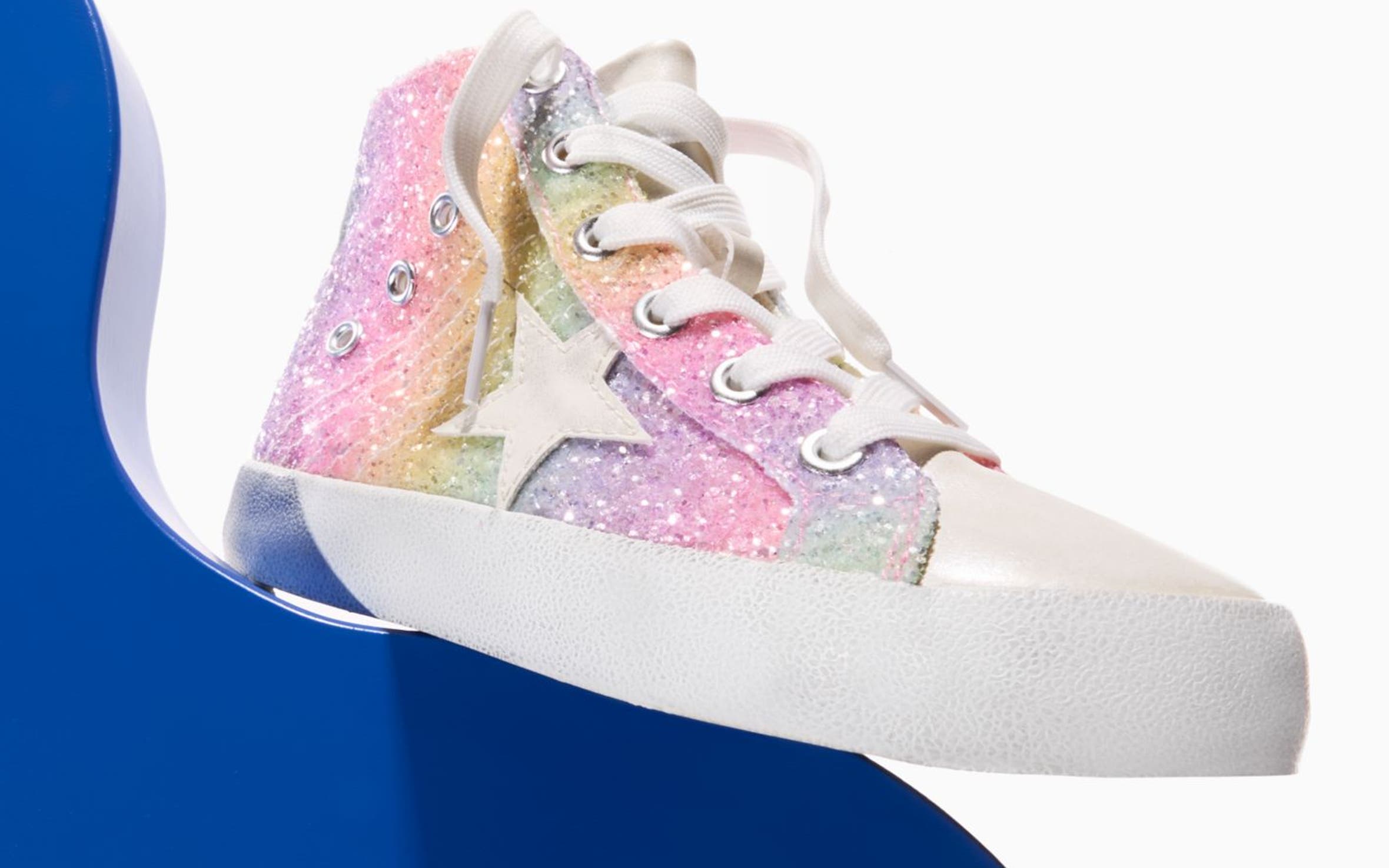 A colorful, sparkly sneaker with a star motif.