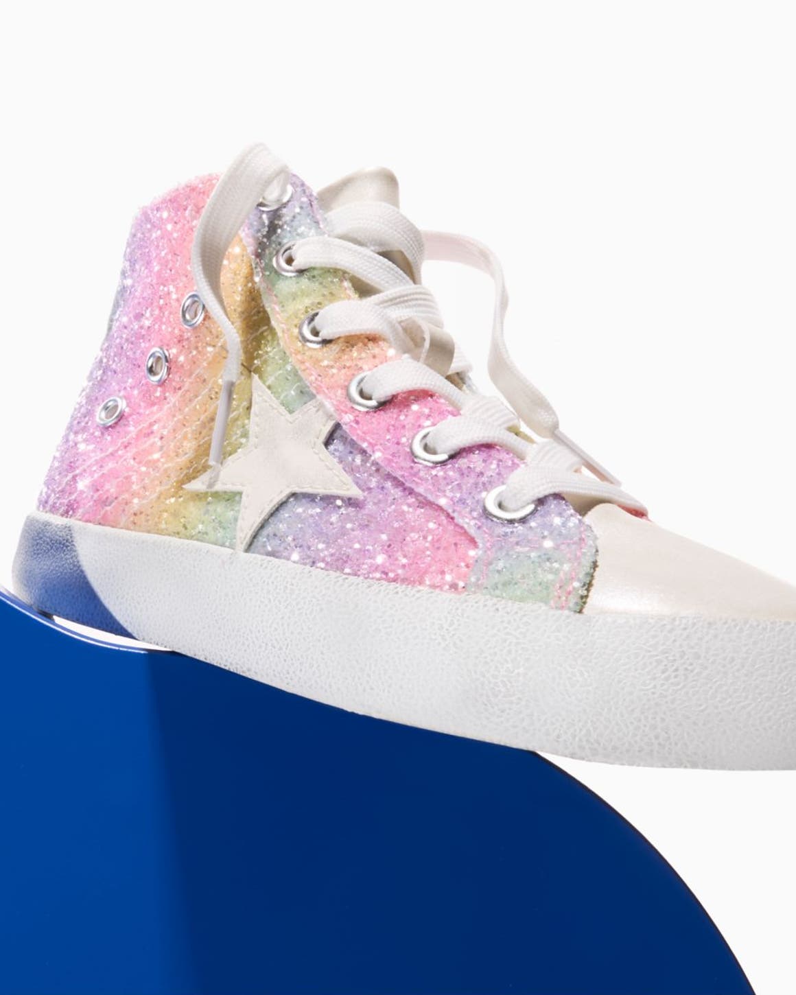 A colorful, sparkly sneaker with a star motif.