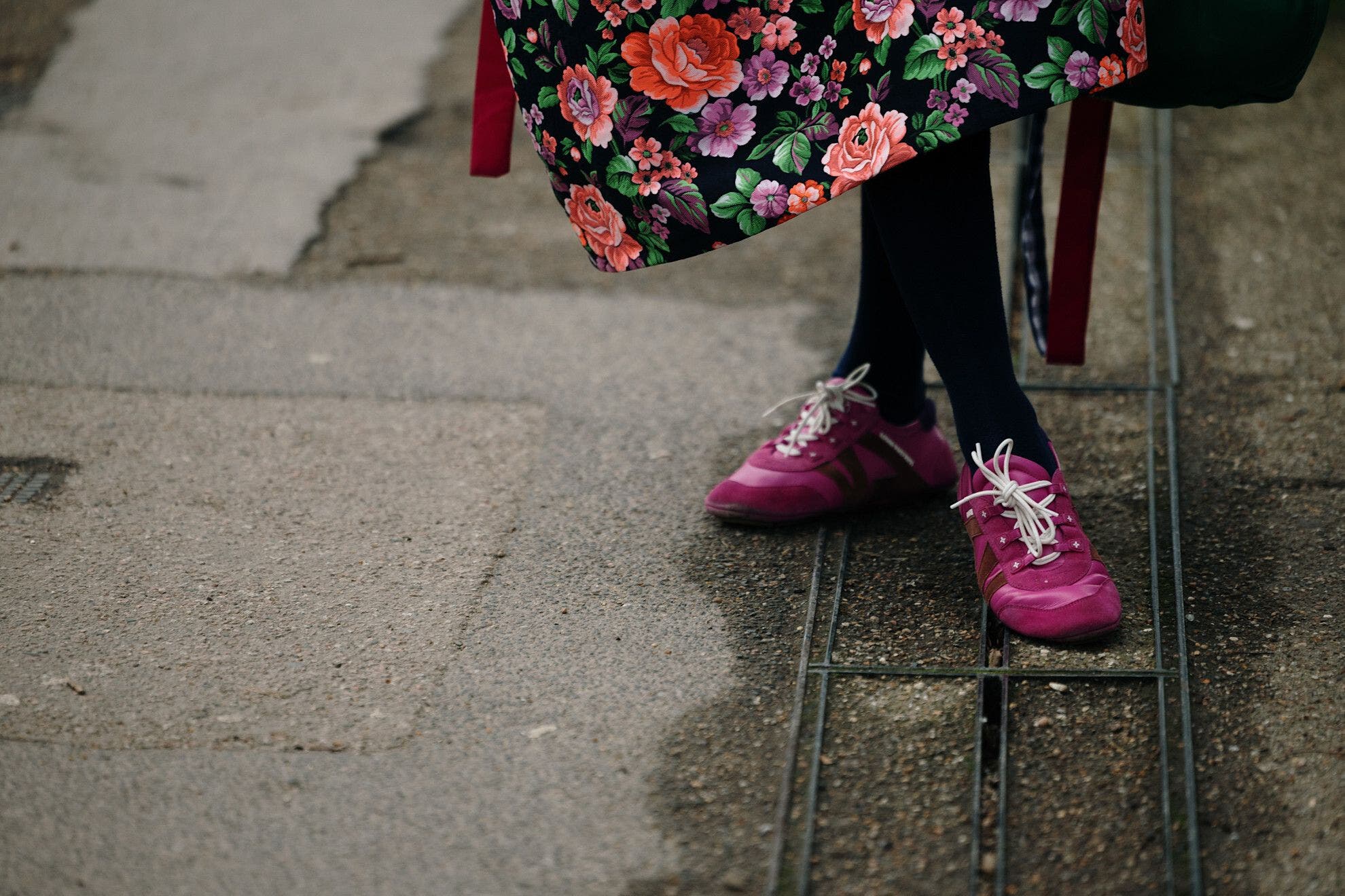 Person wearing pink sneakers at London Fashion Week.