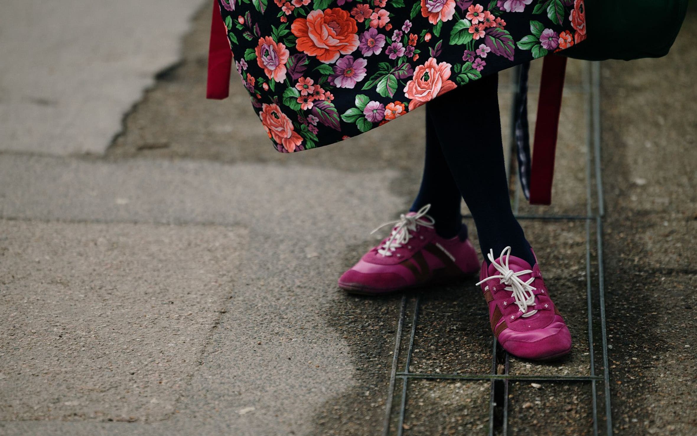Person wearing pink sneakers at London Fashion Week.