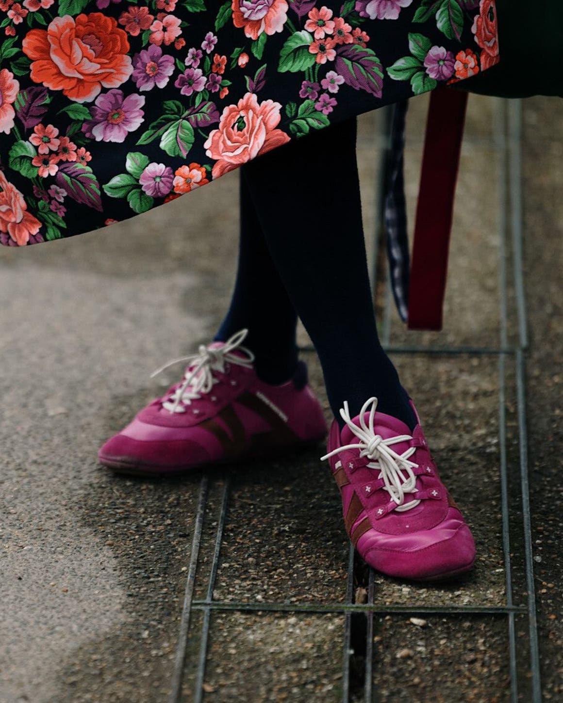 Person wearing pink sneakers at London Fashion Week.