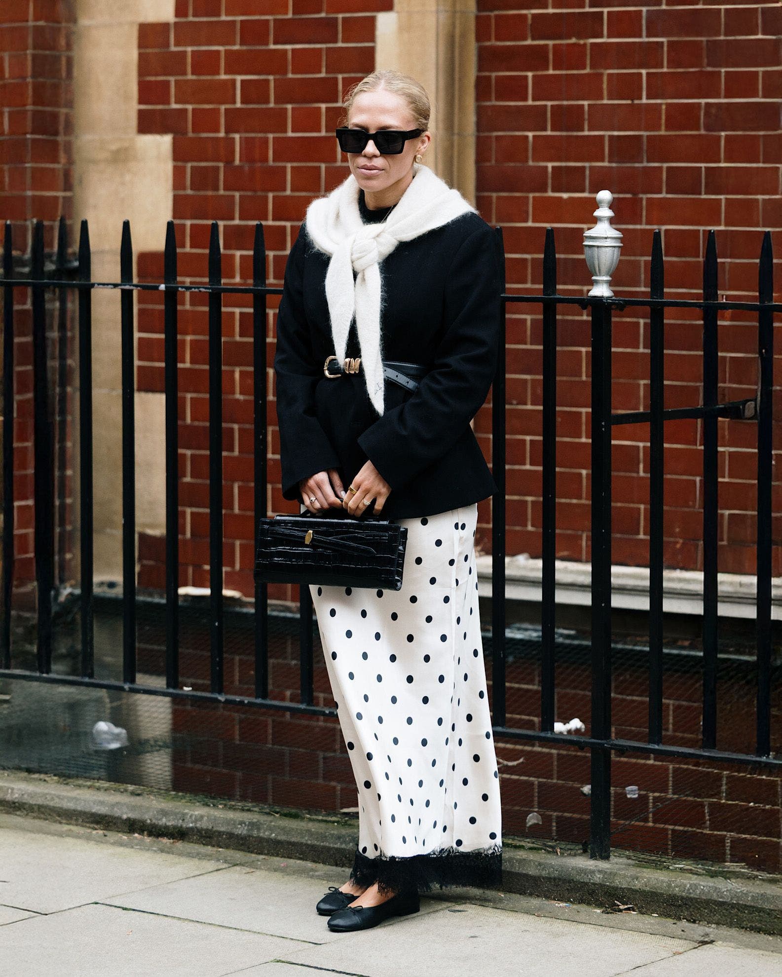 Woman in a black-and-white outfit at London Fashion Week.