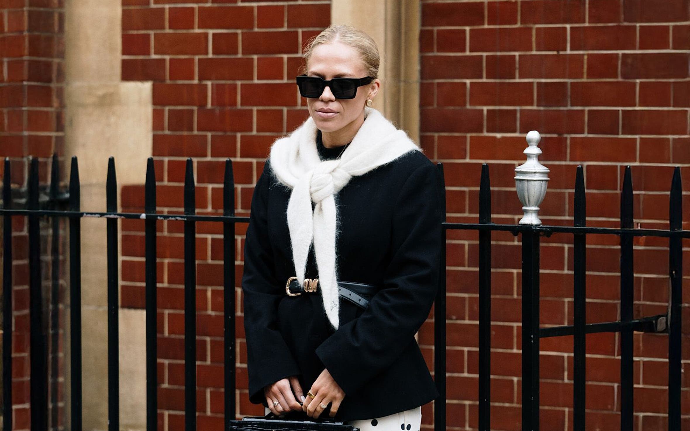 Woman in a black-and-white outfit at London Fashion Week.