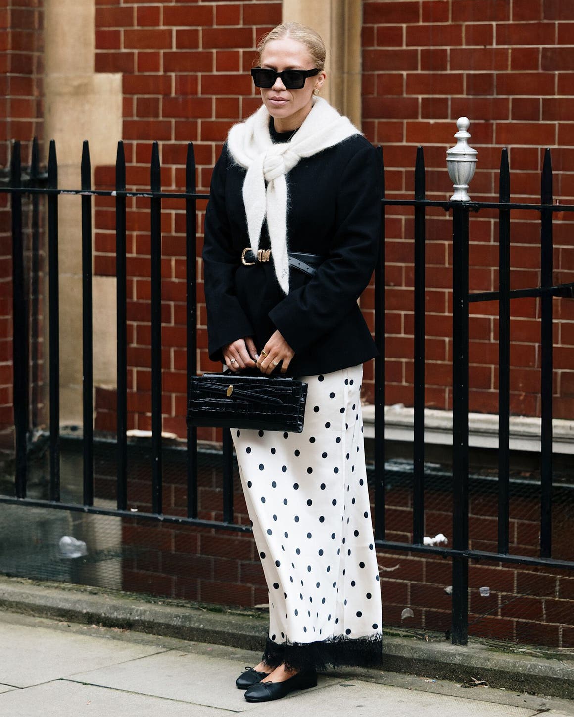 Woman in a black-and-white outfit at London Fashion Week.