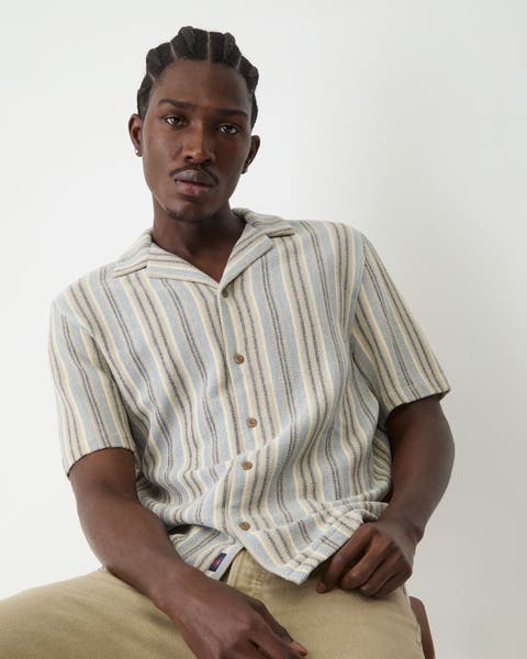 A man wearing striped short sleeve button up.