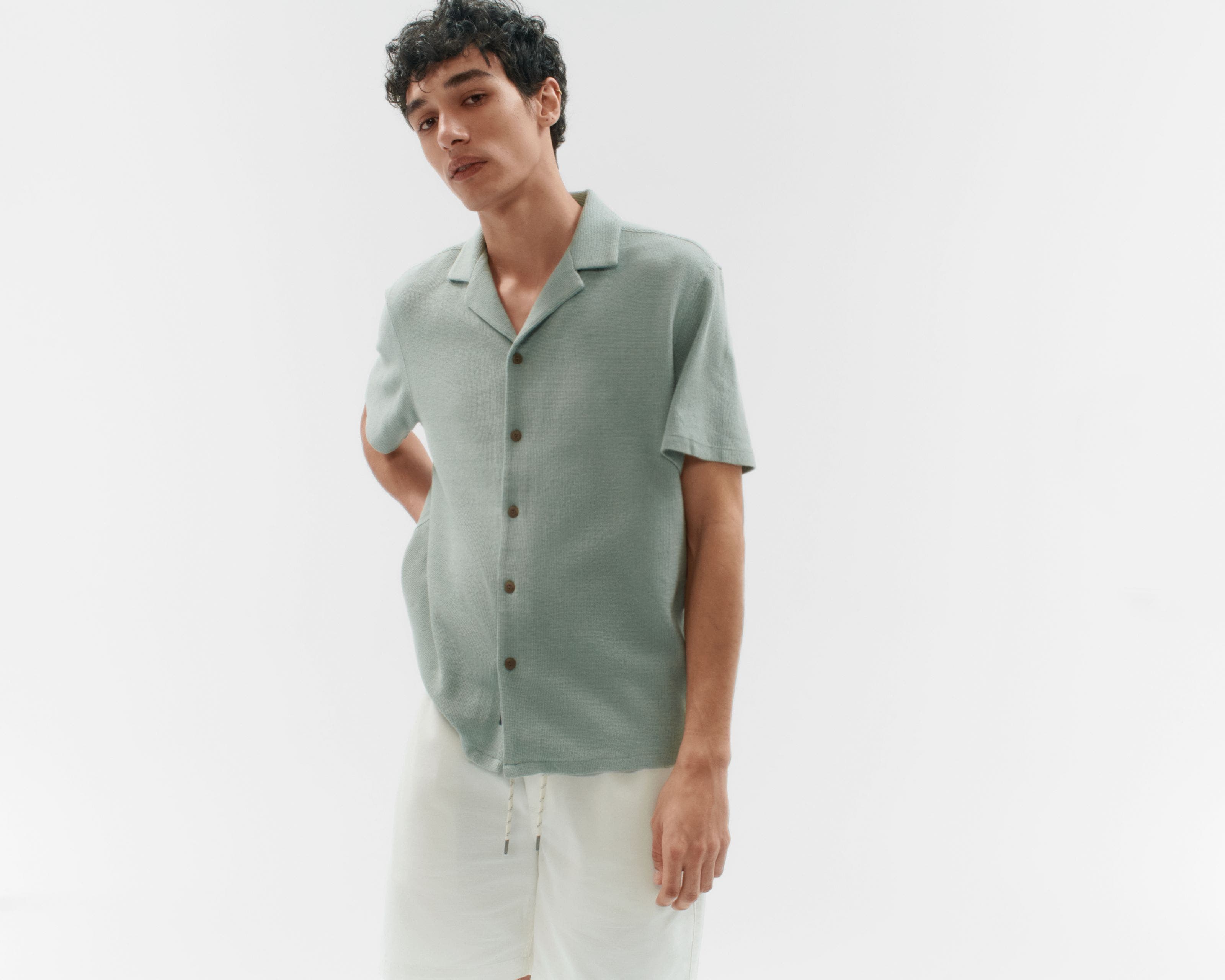 A man wearing a short-sleeve button-up shirt.