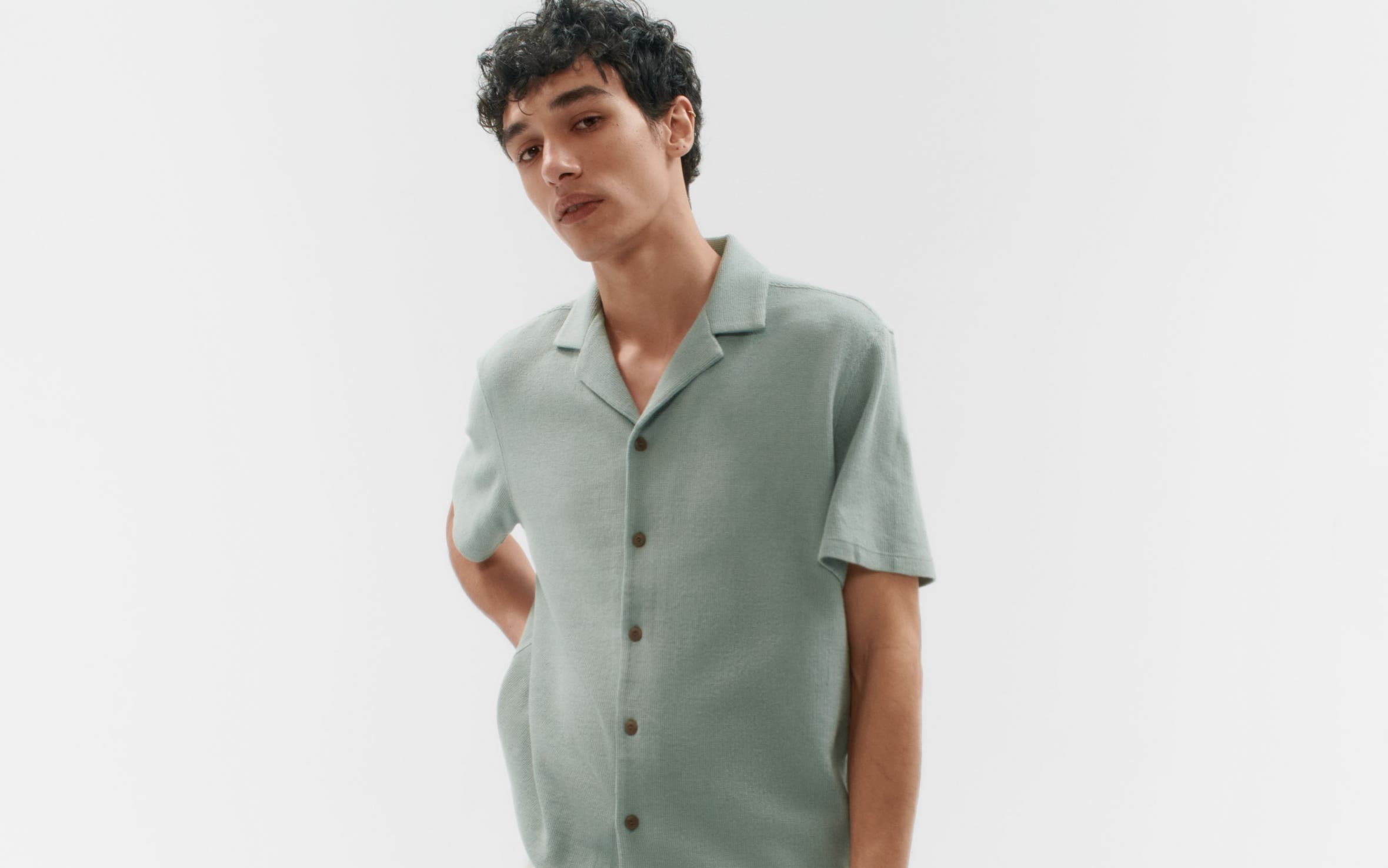 A man wearing a short-sleeve button-up shirt.