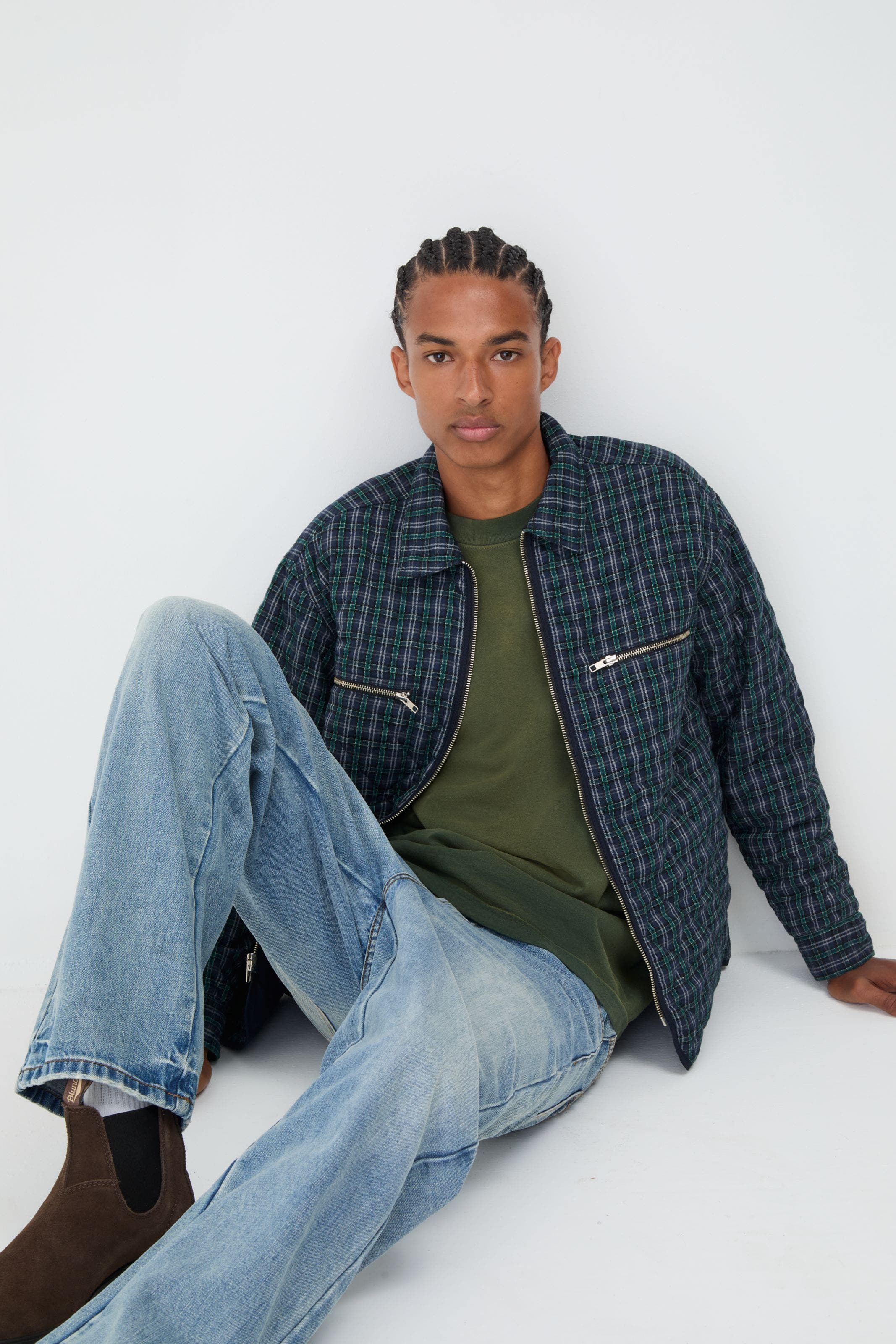 Man wearing a shirt jacket, jeans and boots.
