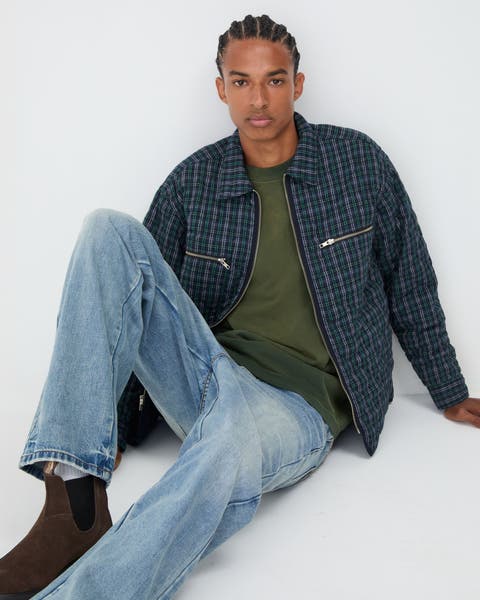 Aman wearing jeans, tee shirt and jacket.