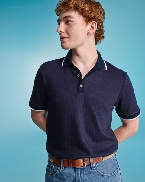 A man wearing a navy blue polo.