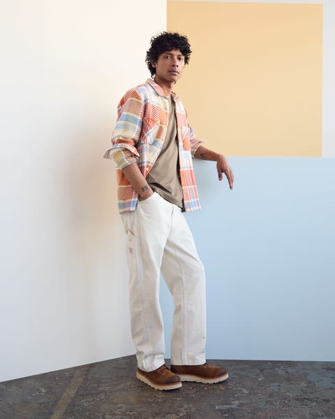 A man wearing wide-leg ivory pants.