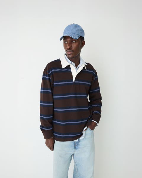 Man in striped rugby shirt and cap.