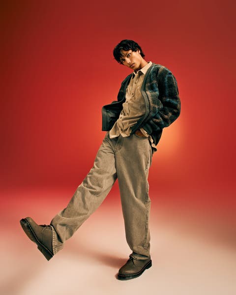 A man wearing pants and a button down shirt.
