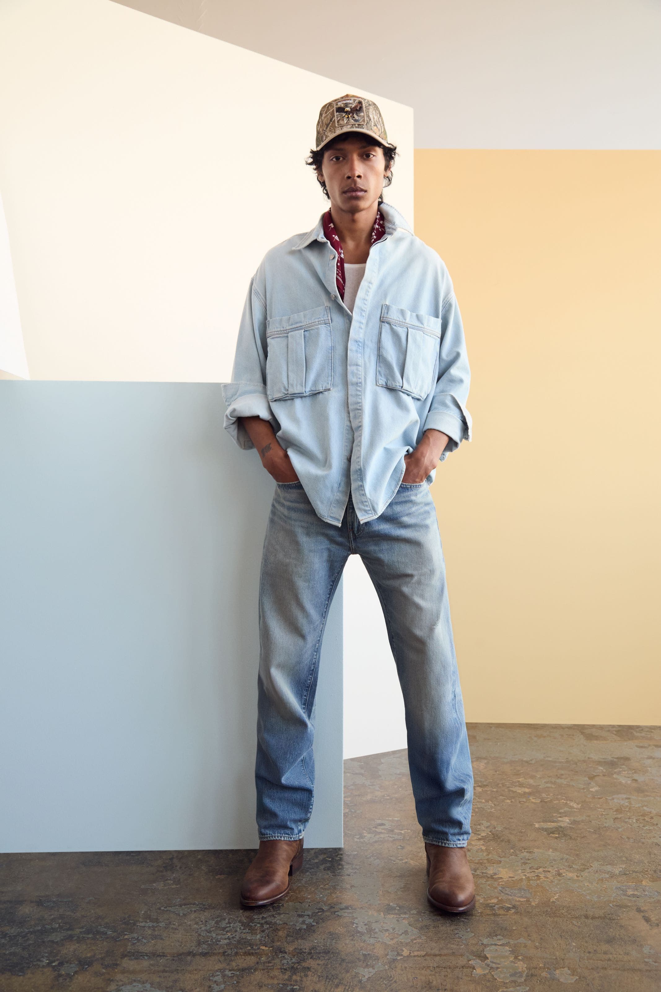 A man wearing a light denim shirt jacket.