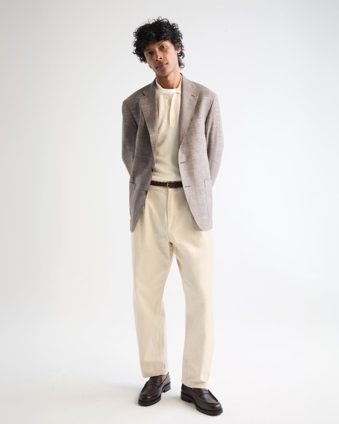 Man wearing a blazer, shirt, trousers and loafers.