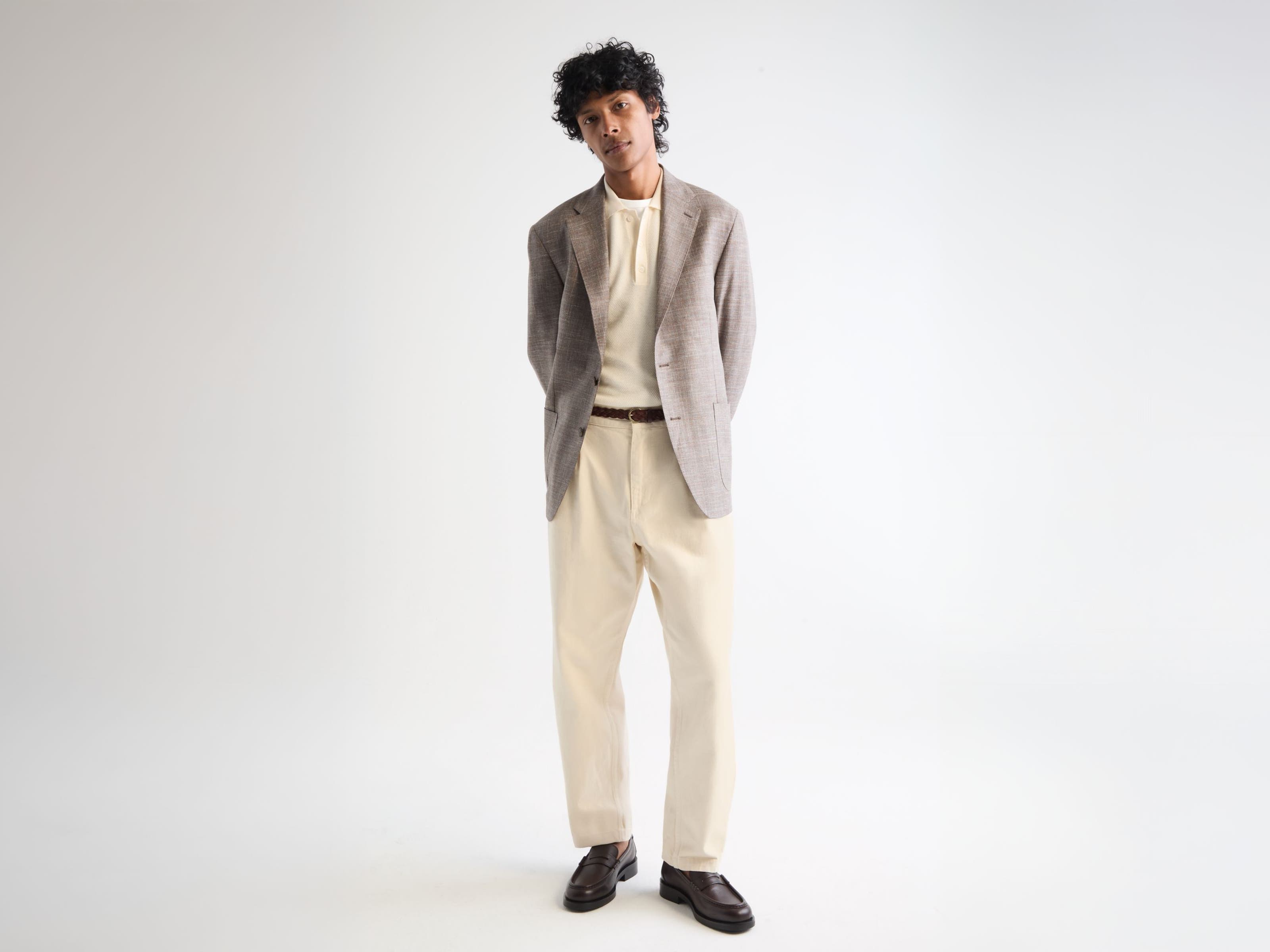 Man wearing a blazer, shirt, trousers and loafers.