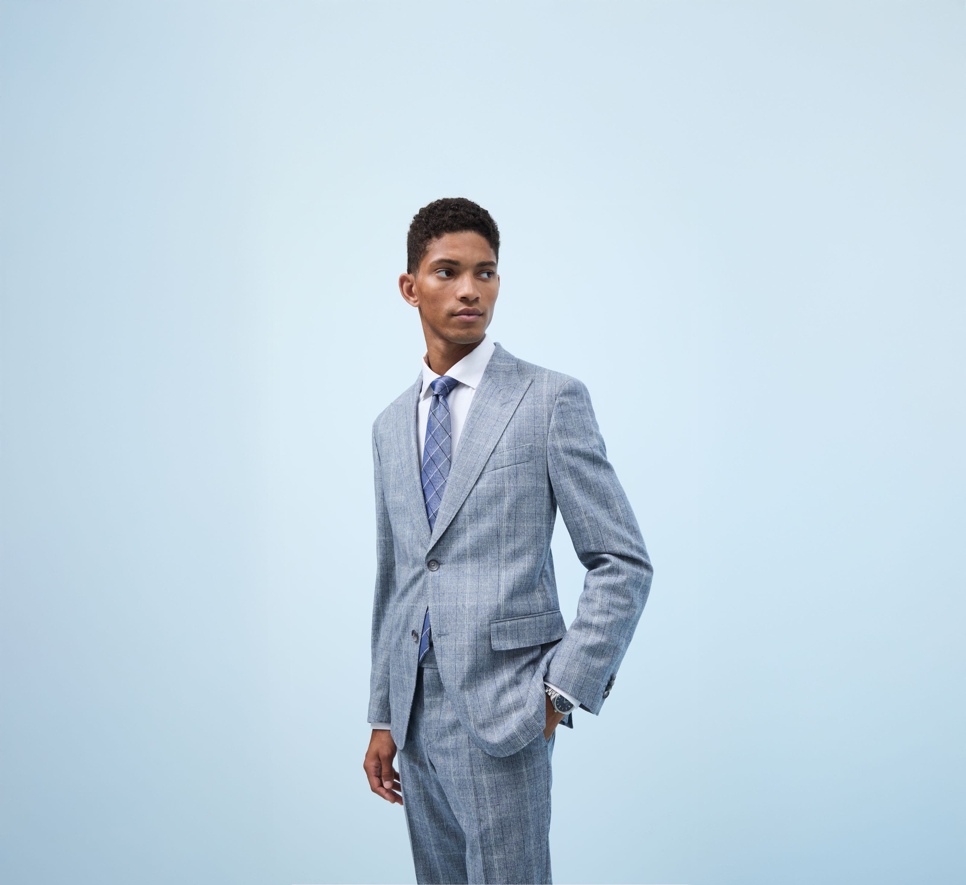 A man wearing a grey plaid suit.