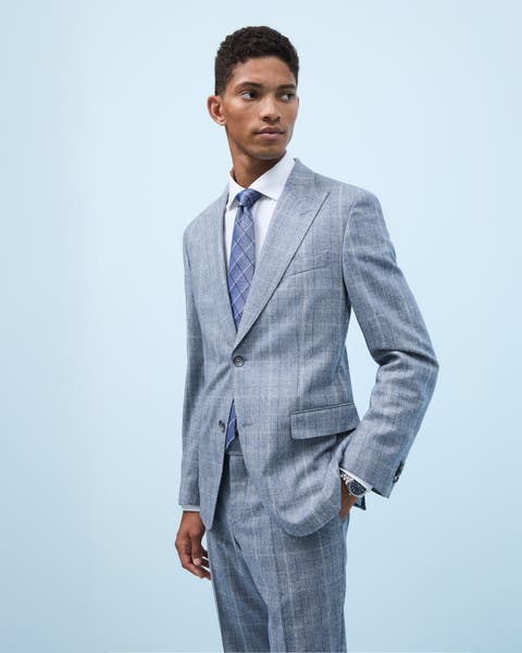 A man wearing a grey plaid suit.