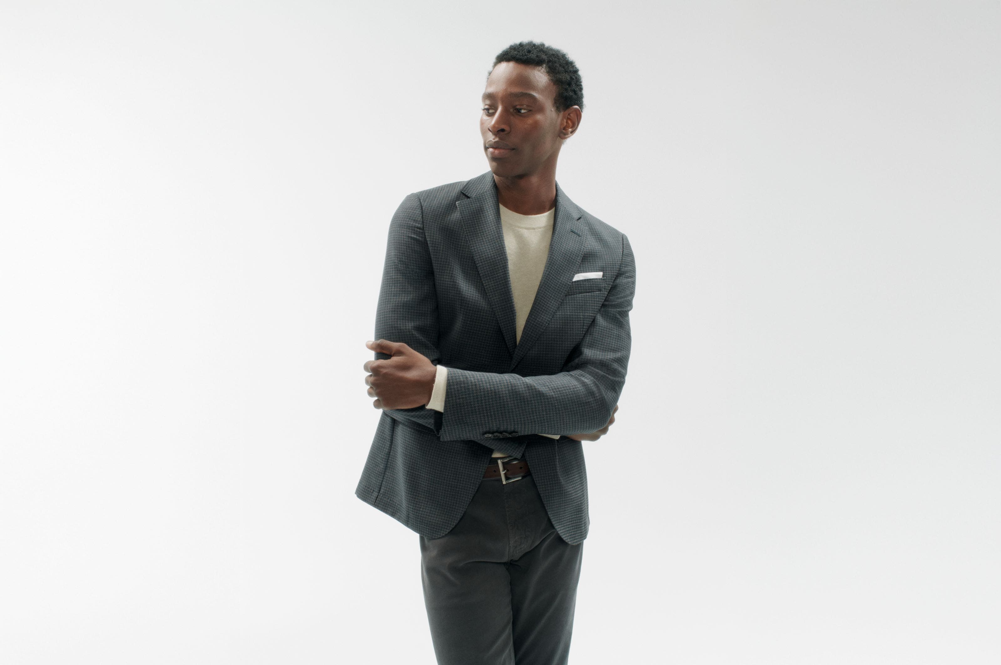 A man wearing a blazer, shirt and pants.