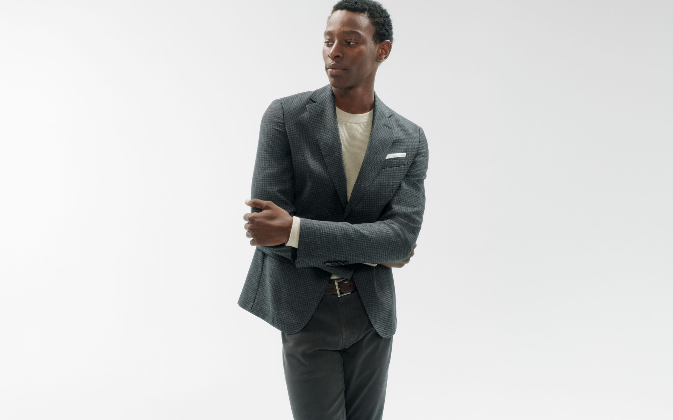 A man wearing a blazer, shirt and pants.