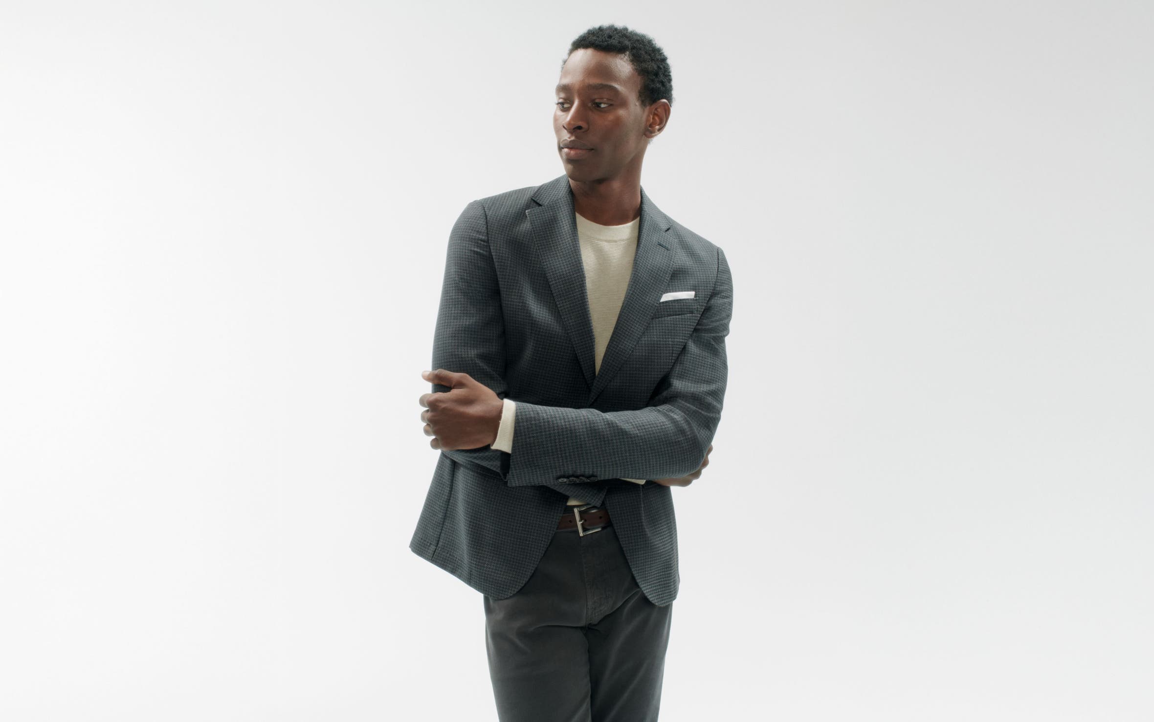 A man wearing a blazer, shirt and pants.