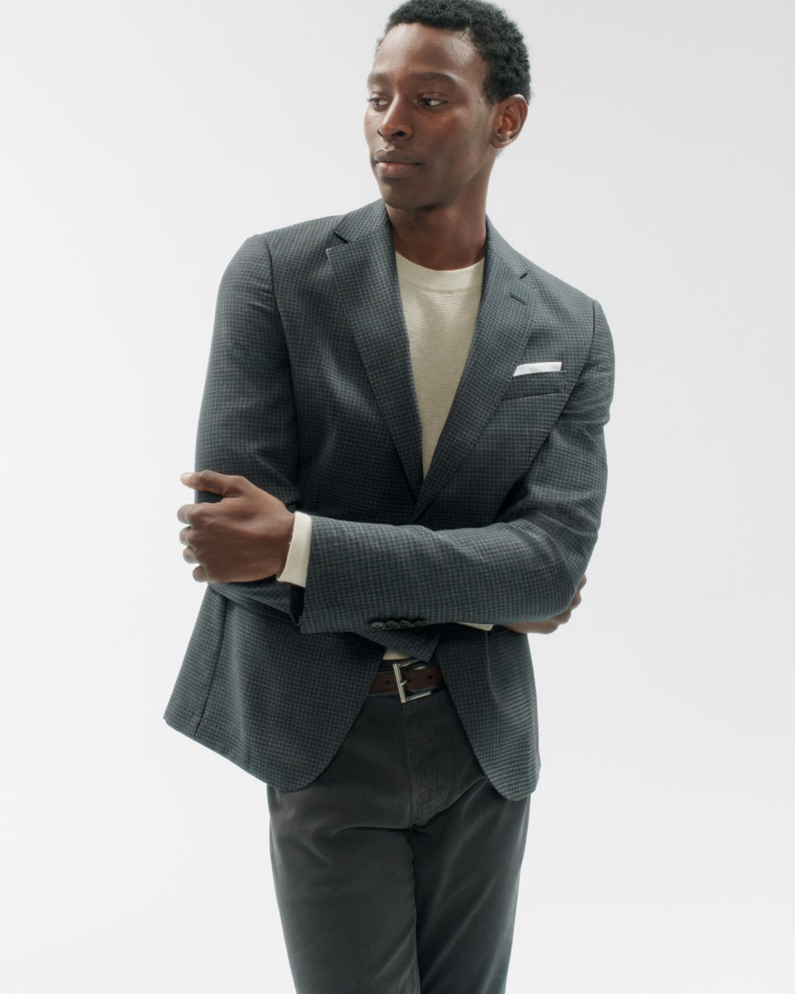 A man wearing a blazer, shirt and pants.