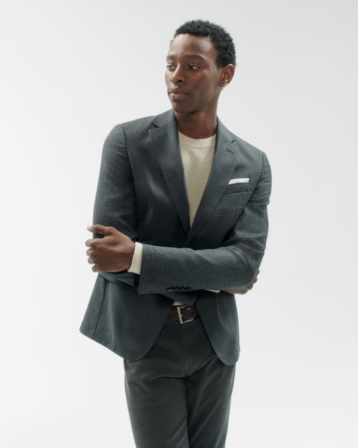 A man wearing a blazer, shirt and pants.