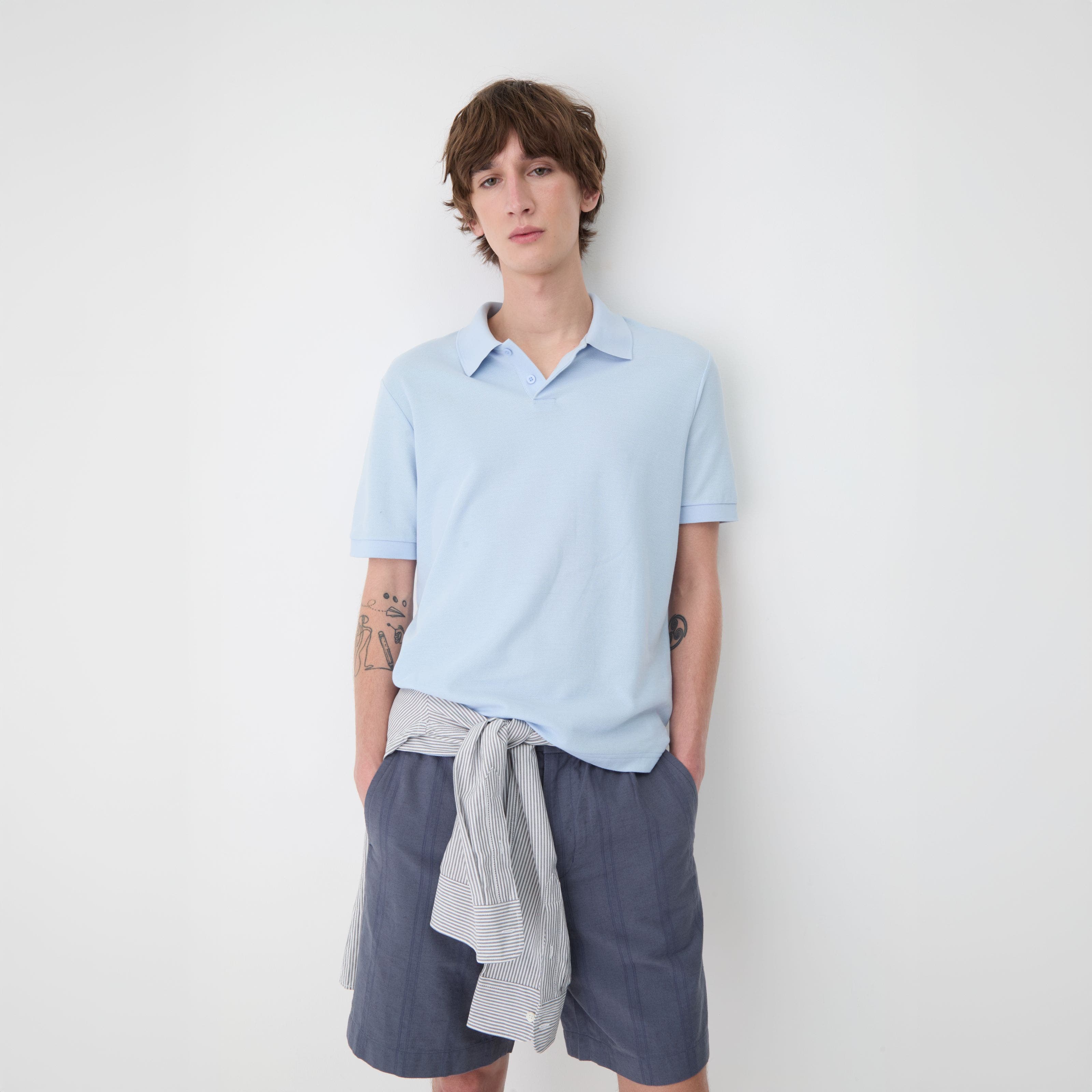 A man wearing a light-blue polo.