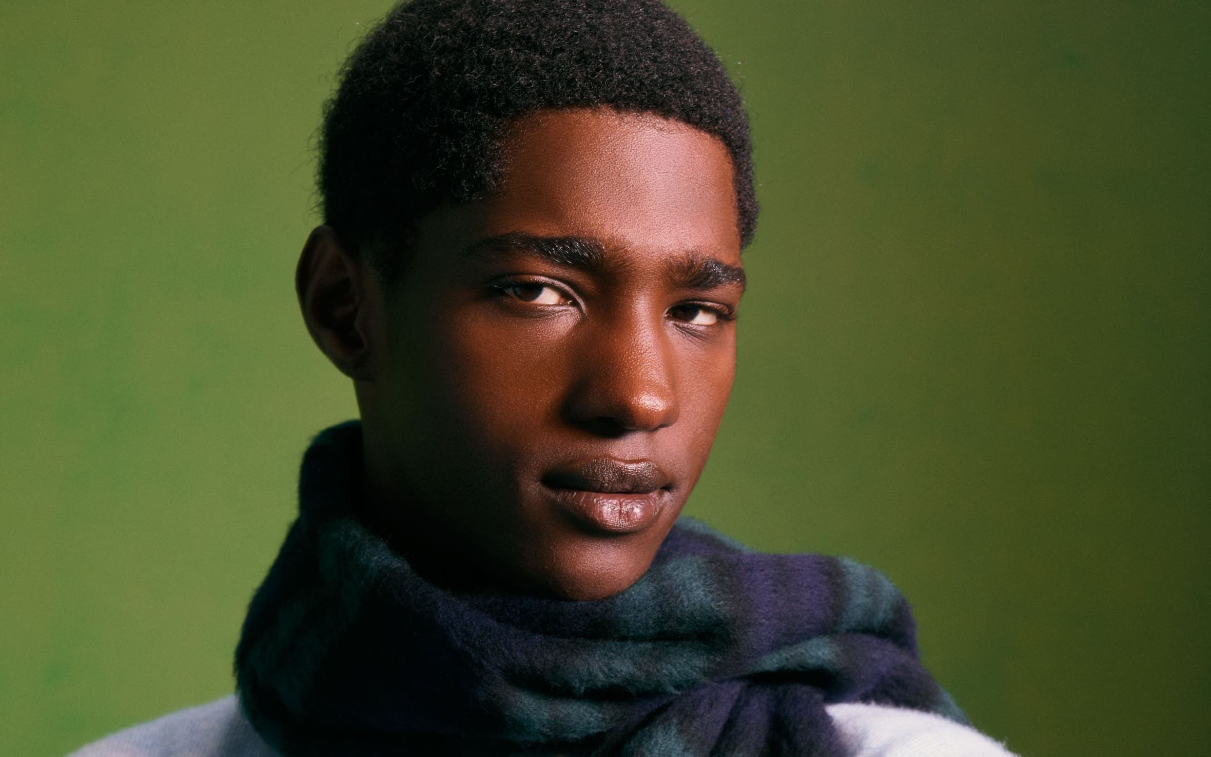 Man wearing a cashmere sweater and scarf.