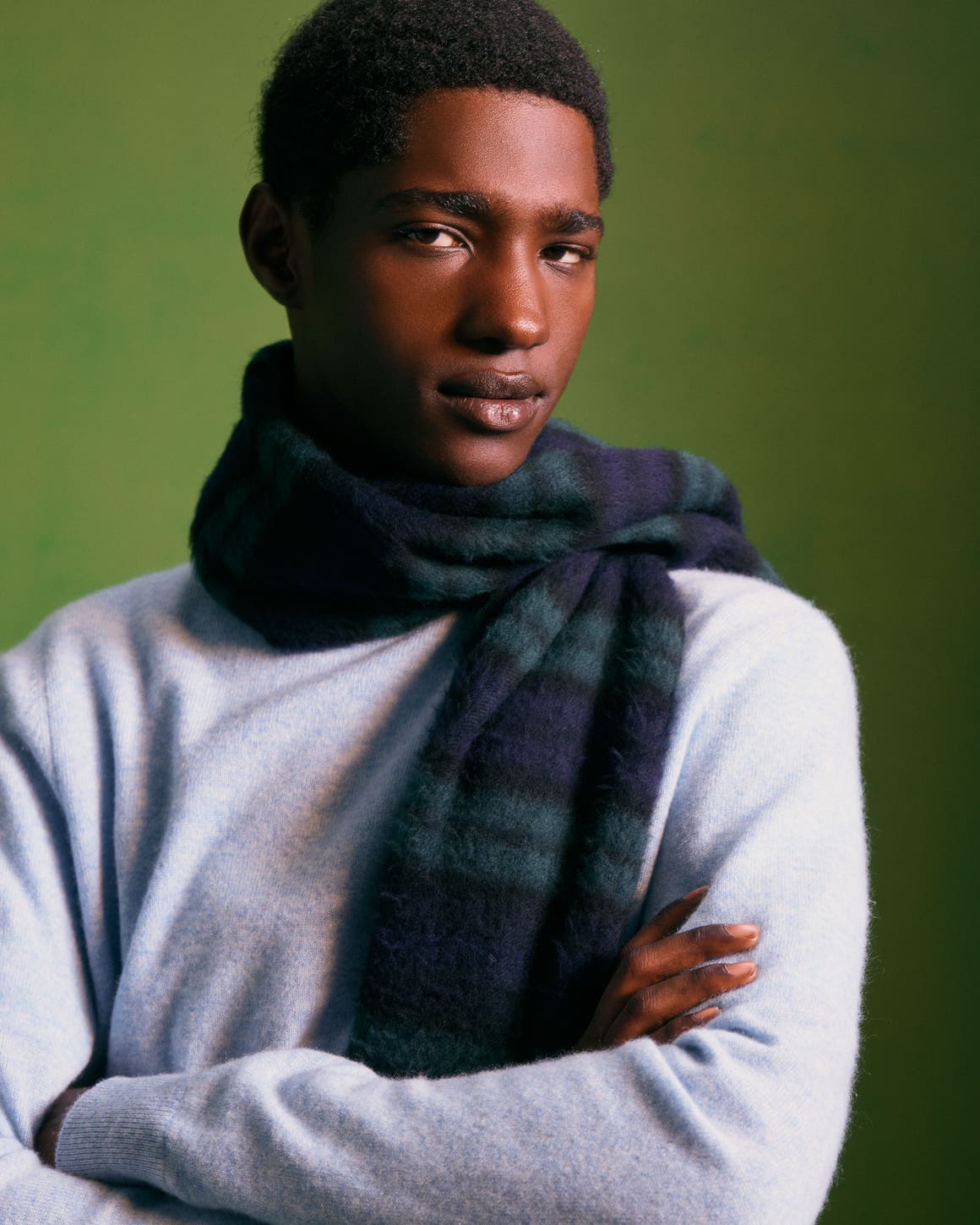 Man wearing a cashmere sweater and scarf.
