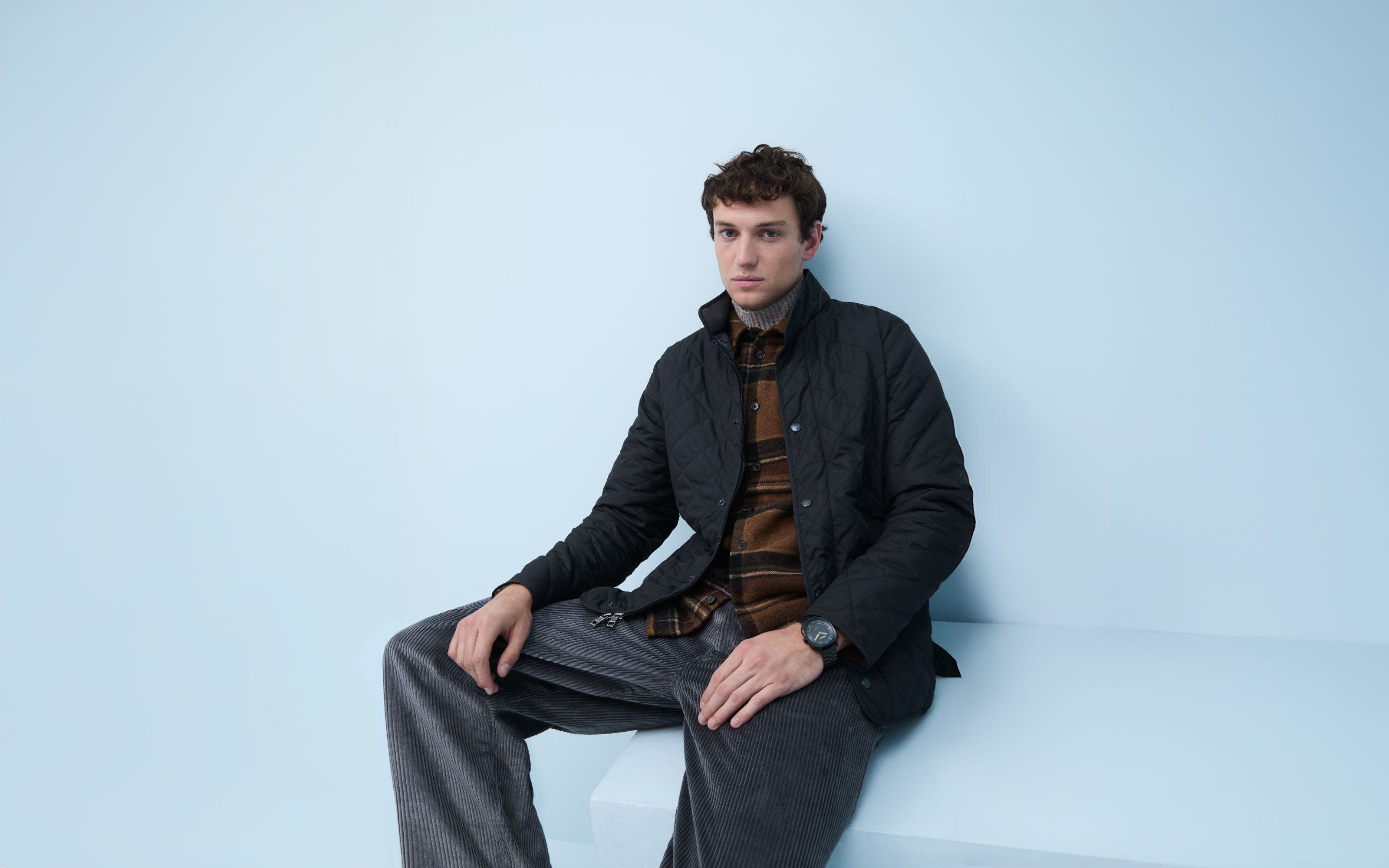 A man wearing a quilted jacket.